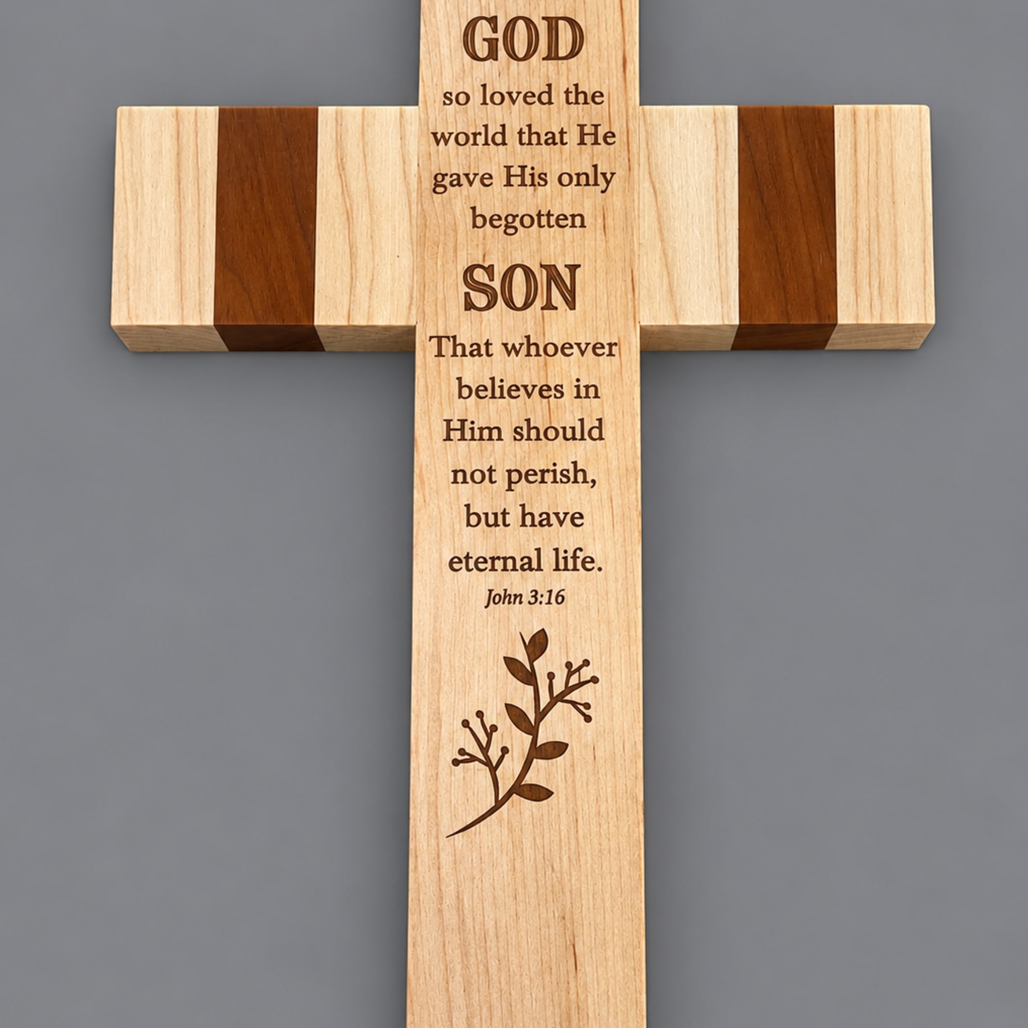 Wooden cross with engraved Bible verse on a gray background