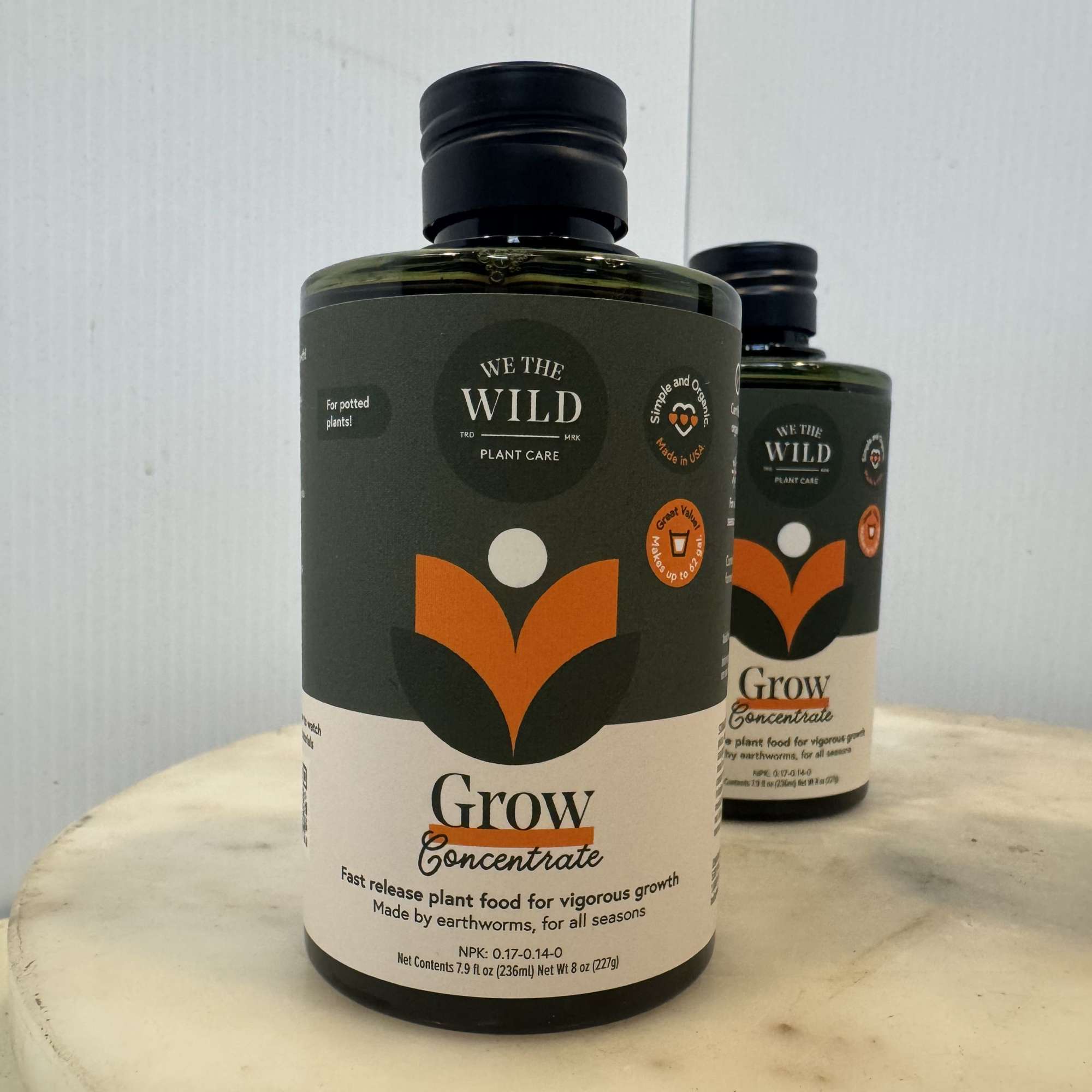 Two bottles of plant fertilizer on a round table
