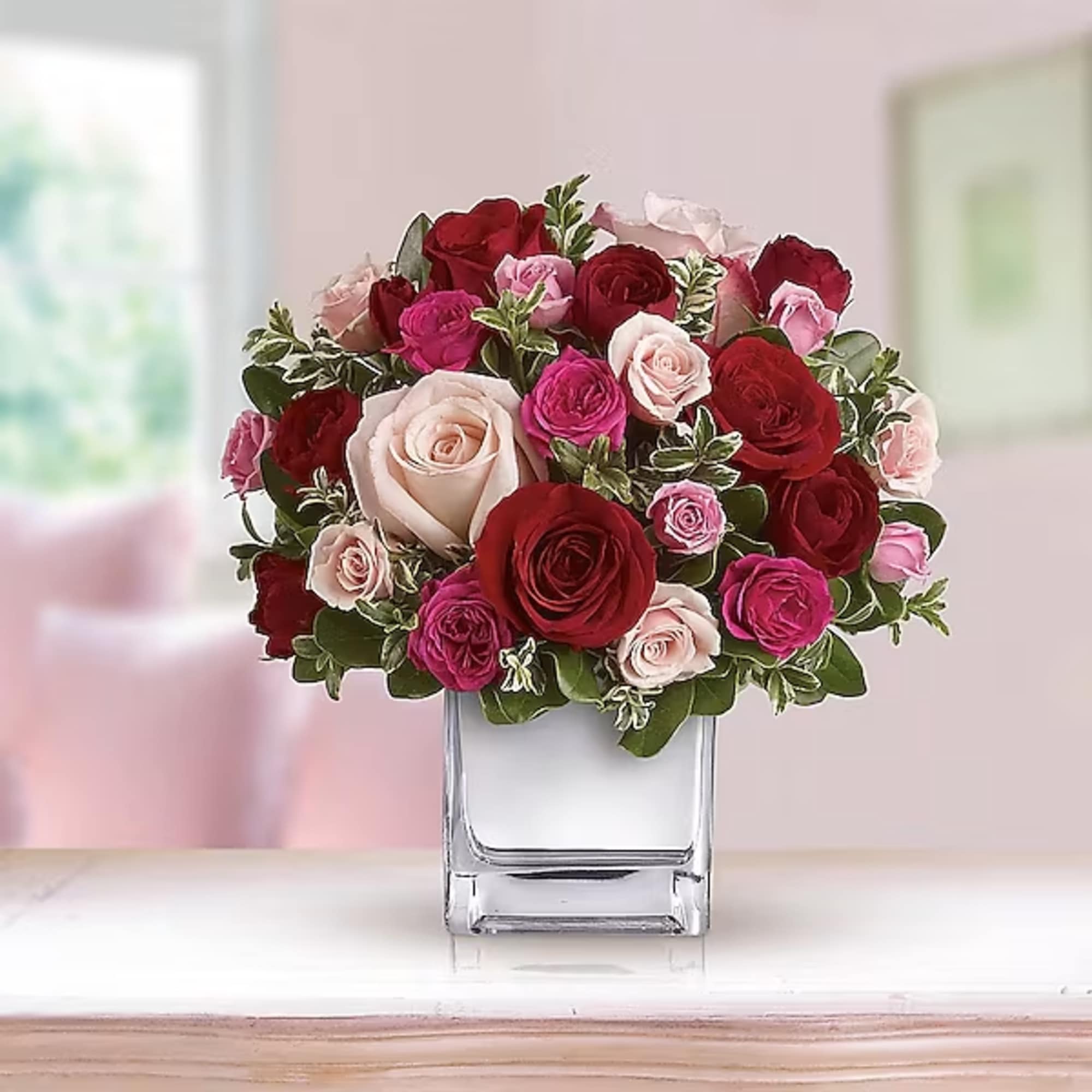 Bouquet of red, pink, and blush roses in a clear glass vase, photo 2 of 2