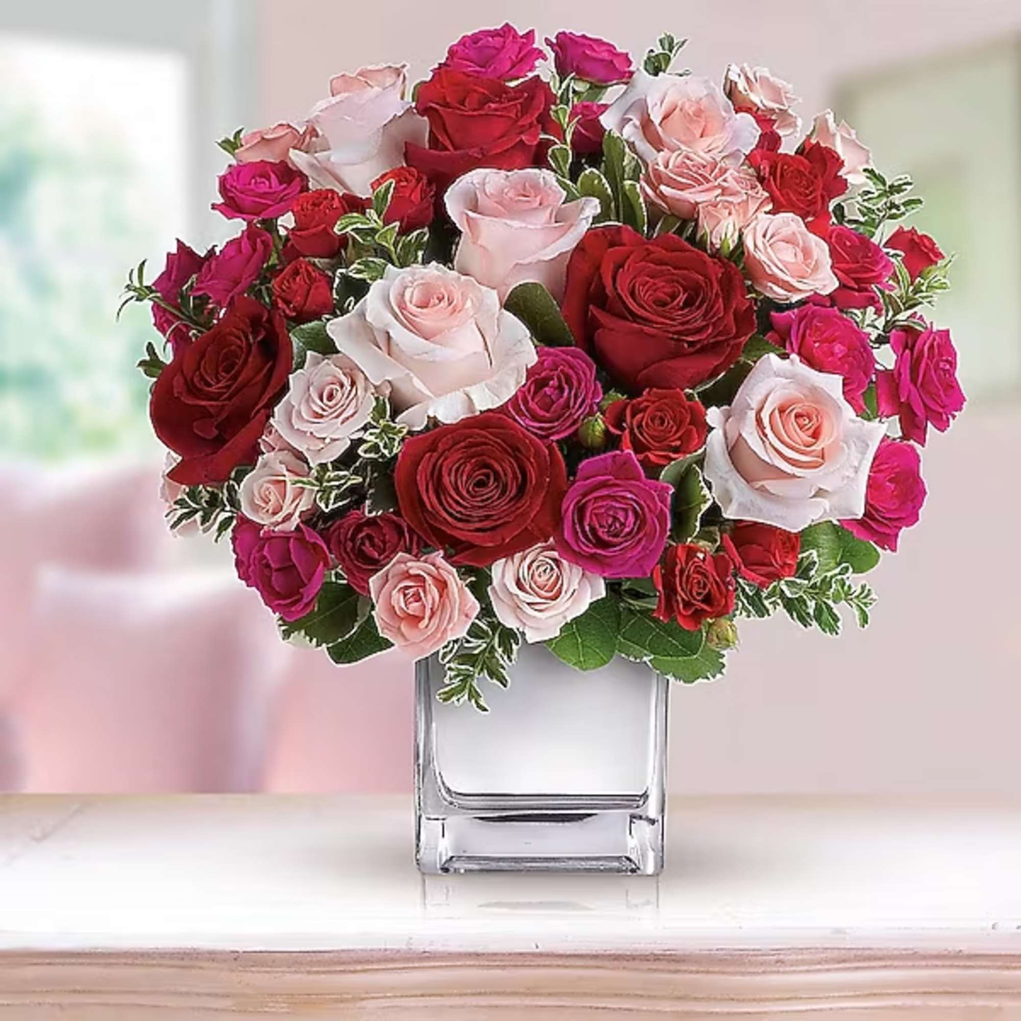Bouquet of pink and red roses in a clear glass vase