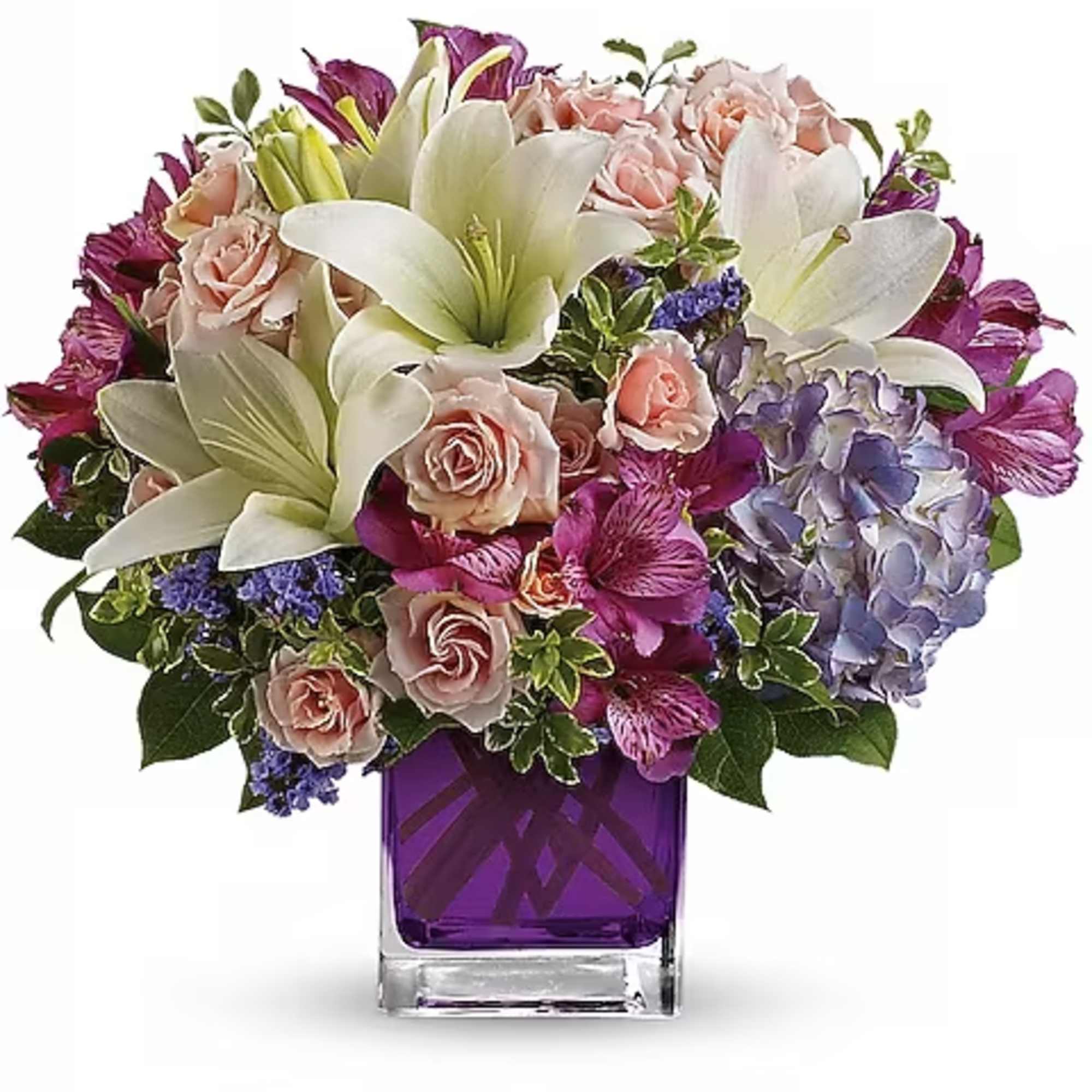 Bouquet of white lilies, pink roses, and purple flowers in a purple glass vase
