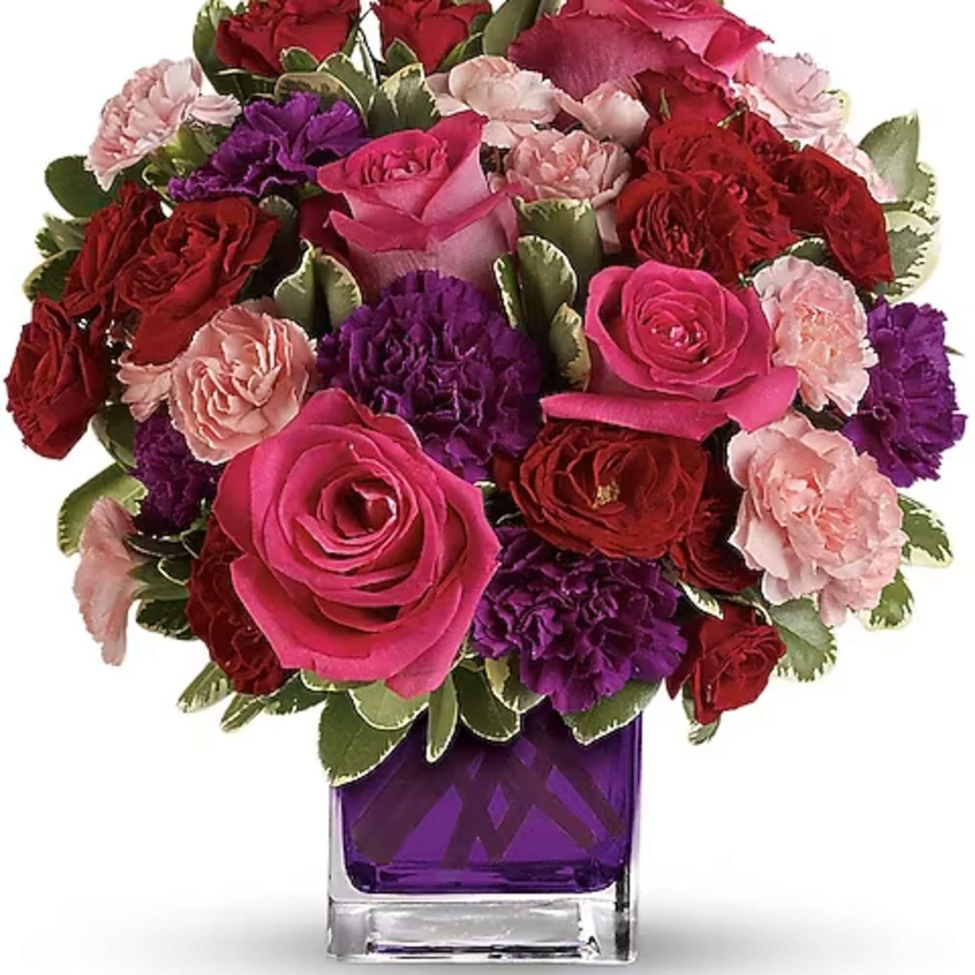 Bouquet of pink, red, and purple flowers in a purple glass vase