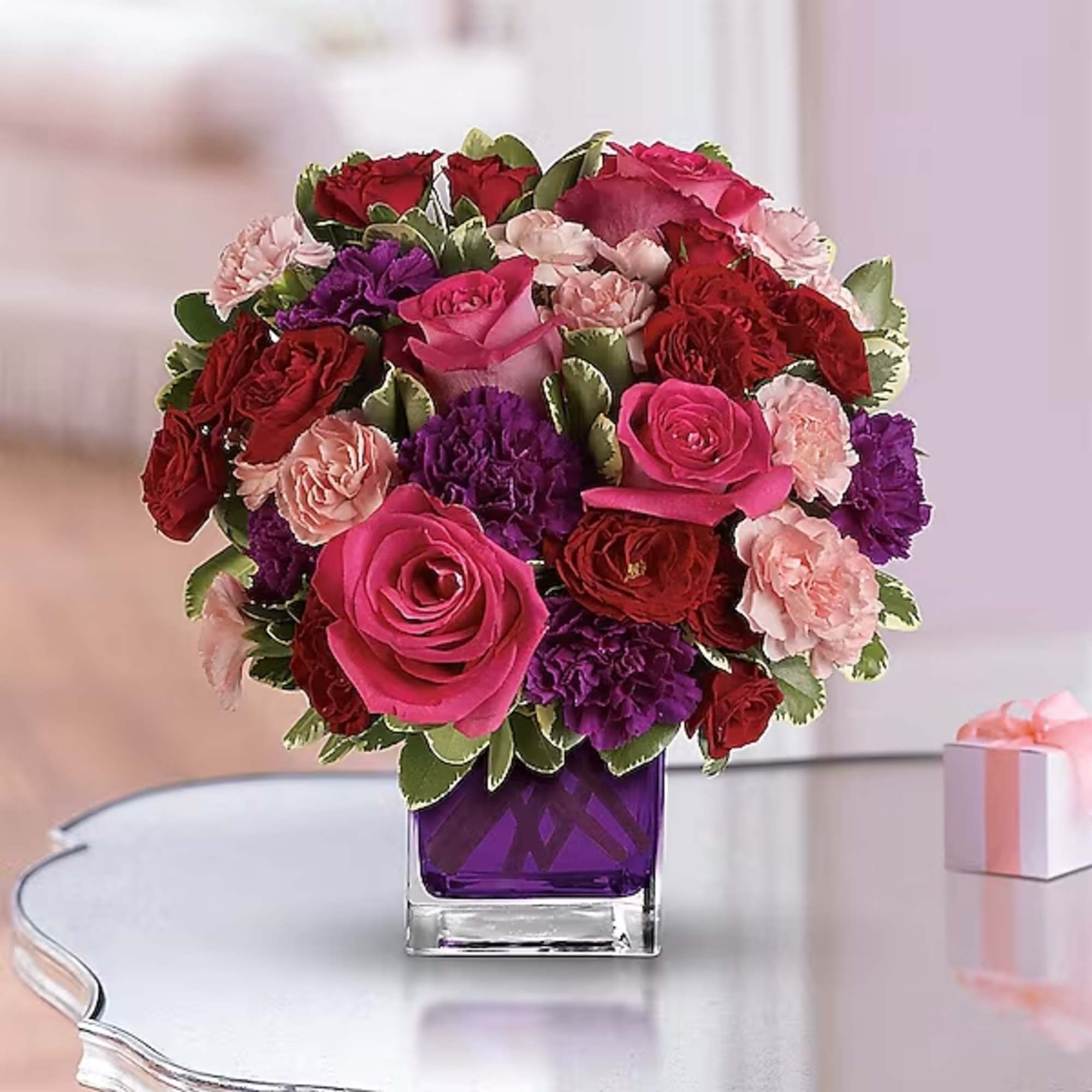 Bouquet of pink, red, and purple flowers in a purple glass vase, photo 2 of 2