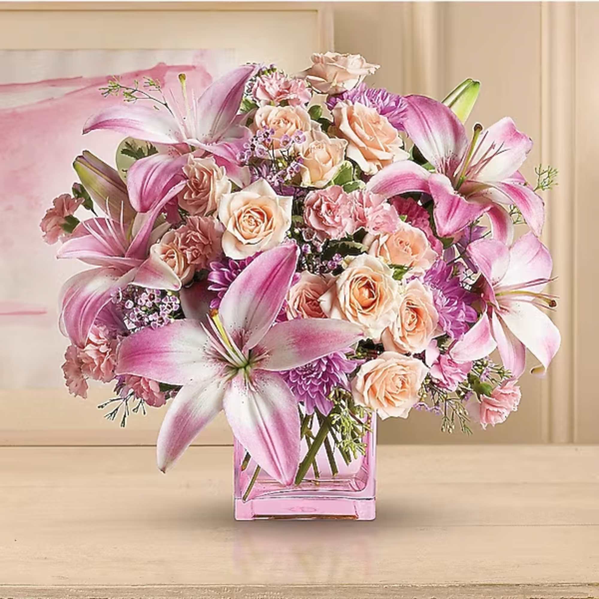 Pink lilies and peach roses arranged in a square glass vase, photo 2 of 2