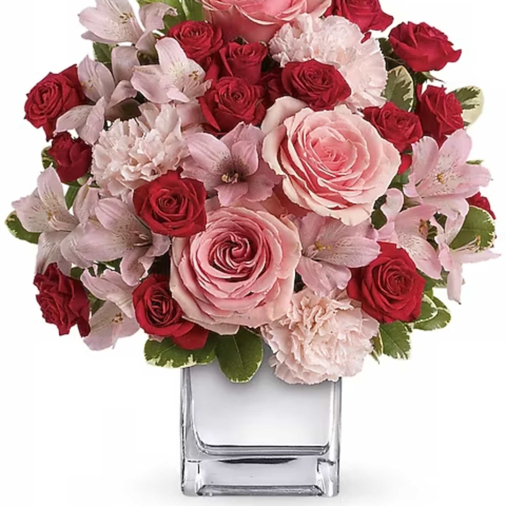 Pink and red rose bouquet in a clear glass vase
