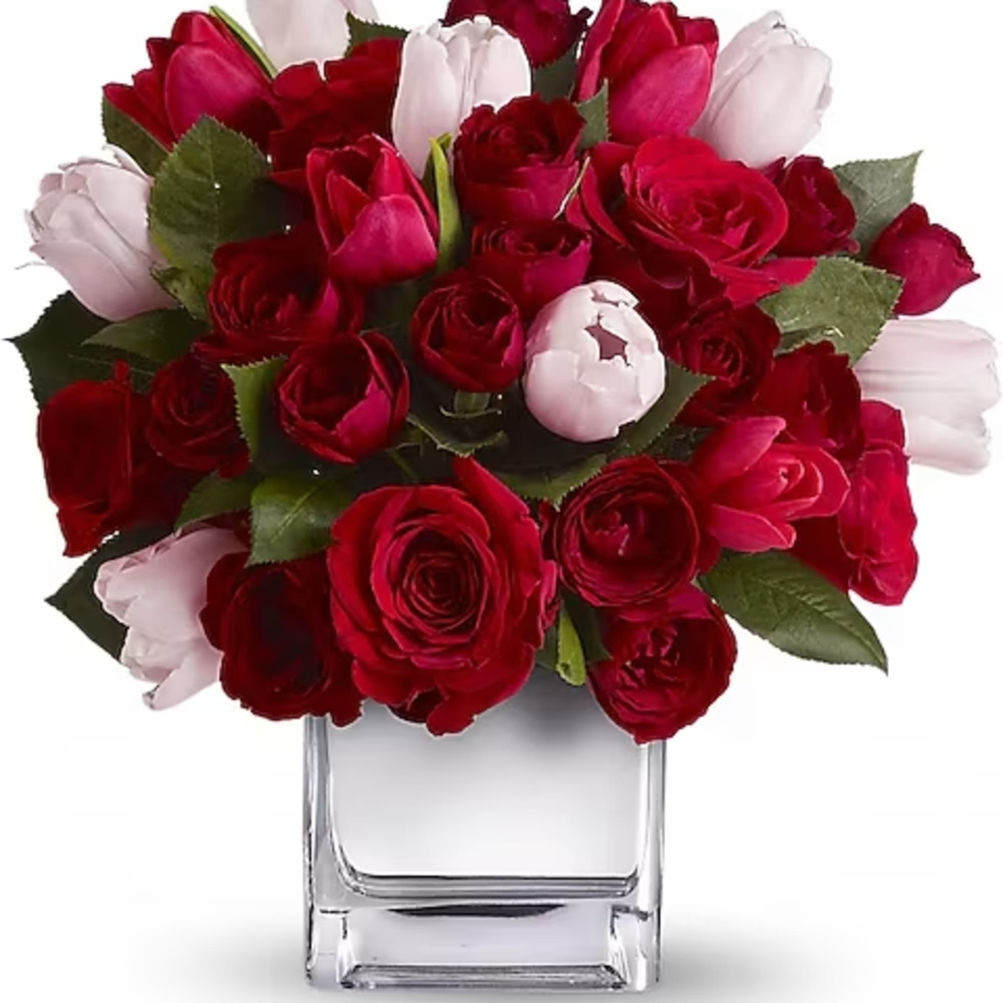 Red and pink tulips arranged in a clear glass vase