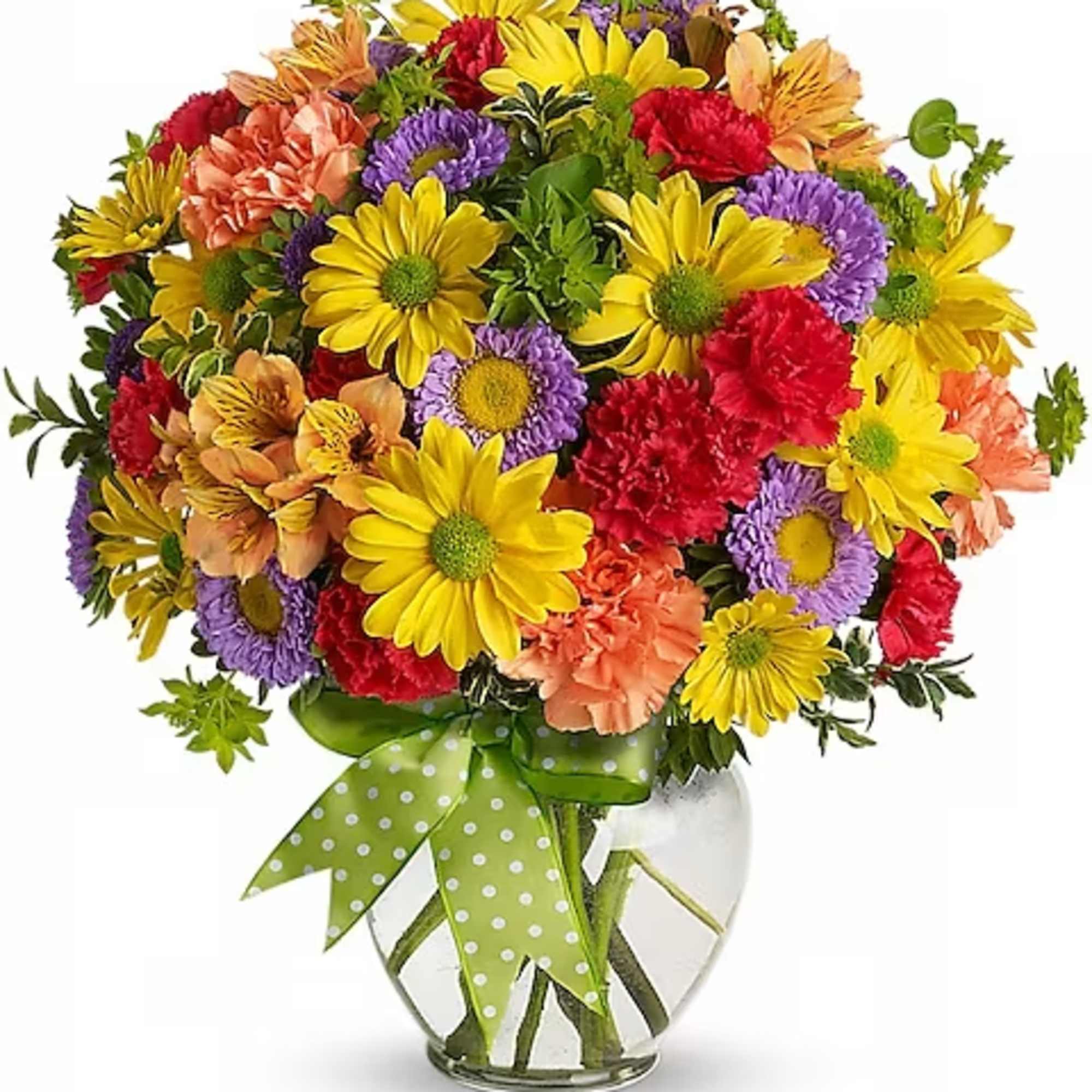Colorful mixed bouquet in a clear glass vase with a green polka-dot ribbon