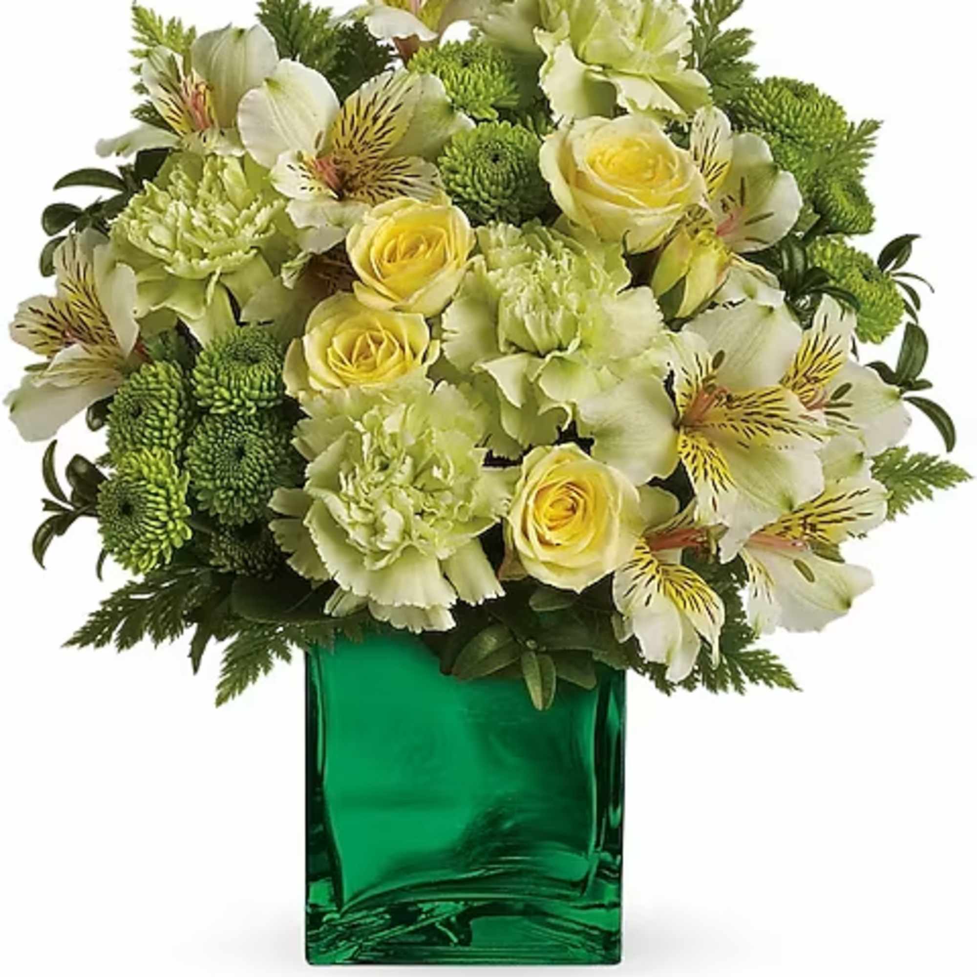 Green and yellow floral arrangement in a square glass vase