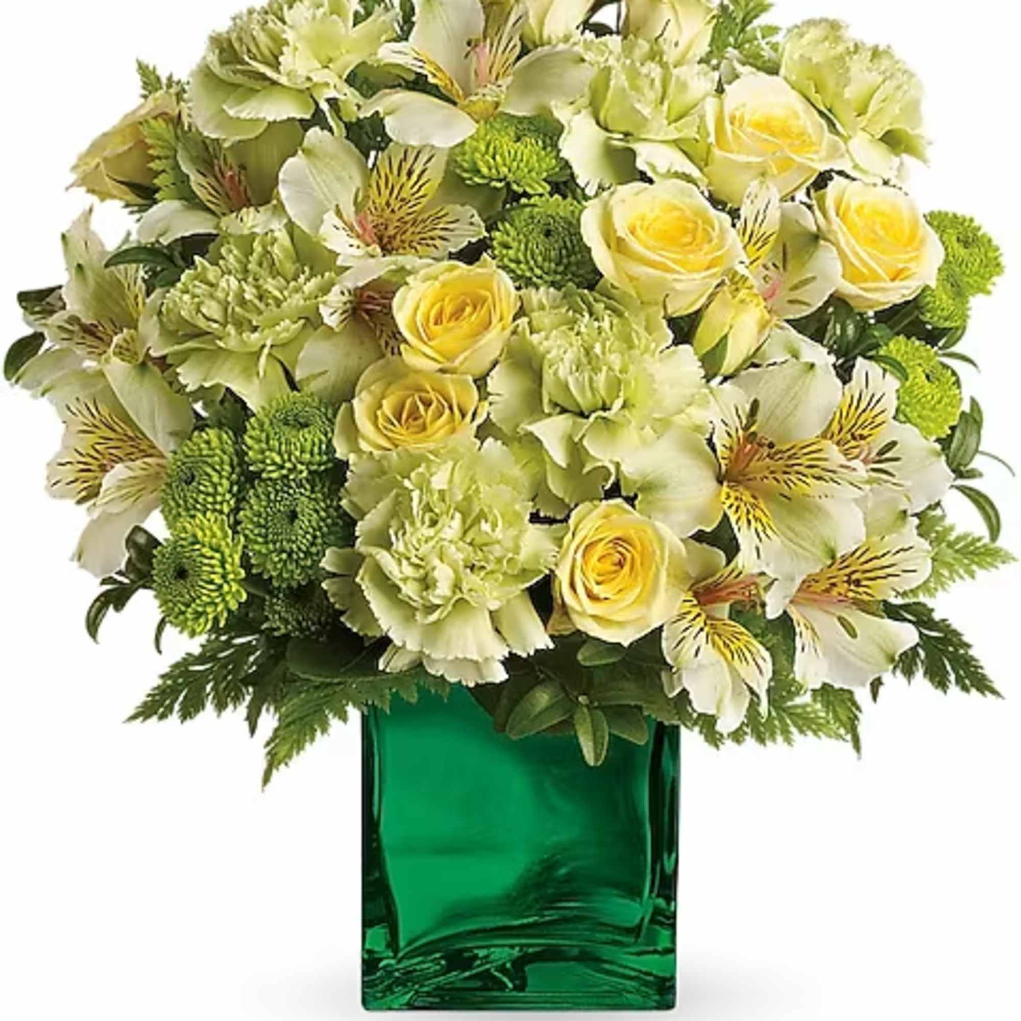 Yellow roses and pale green flowers in a green glass vase