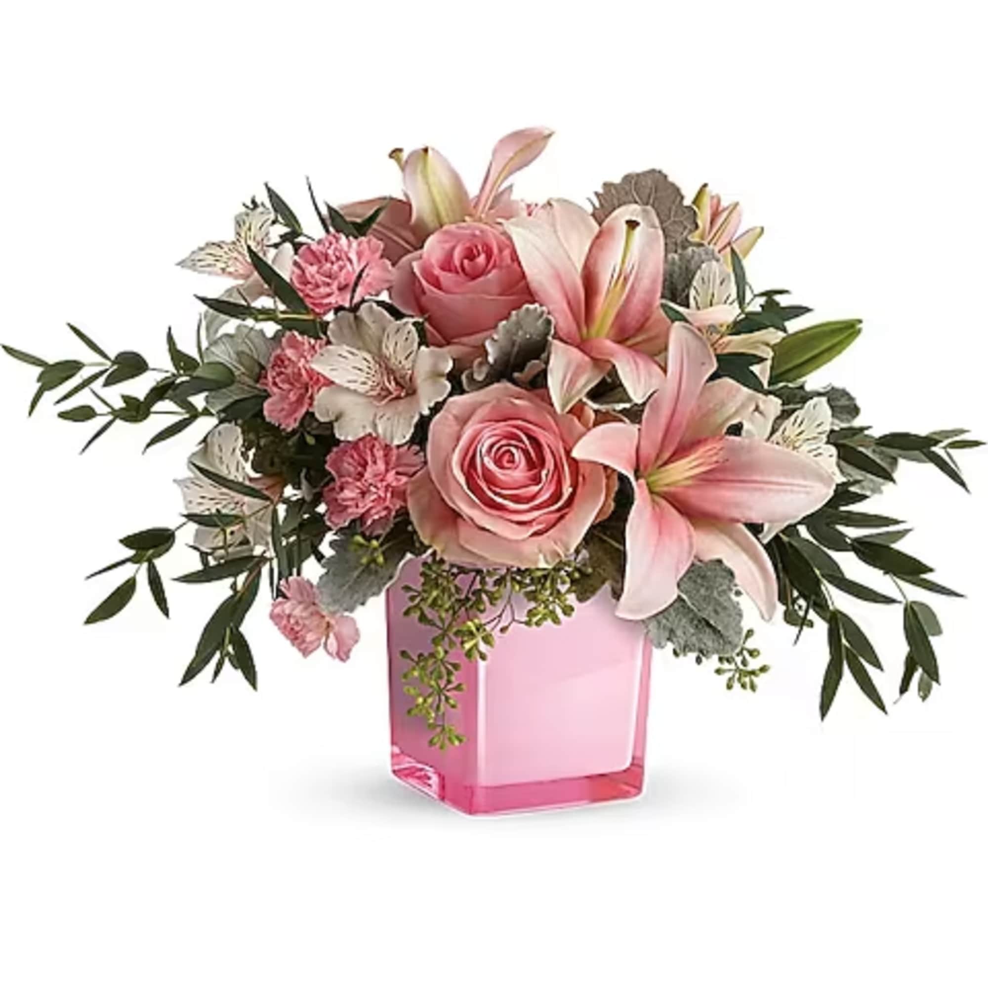 Pink roses and lilies arranged in a pink glass vase