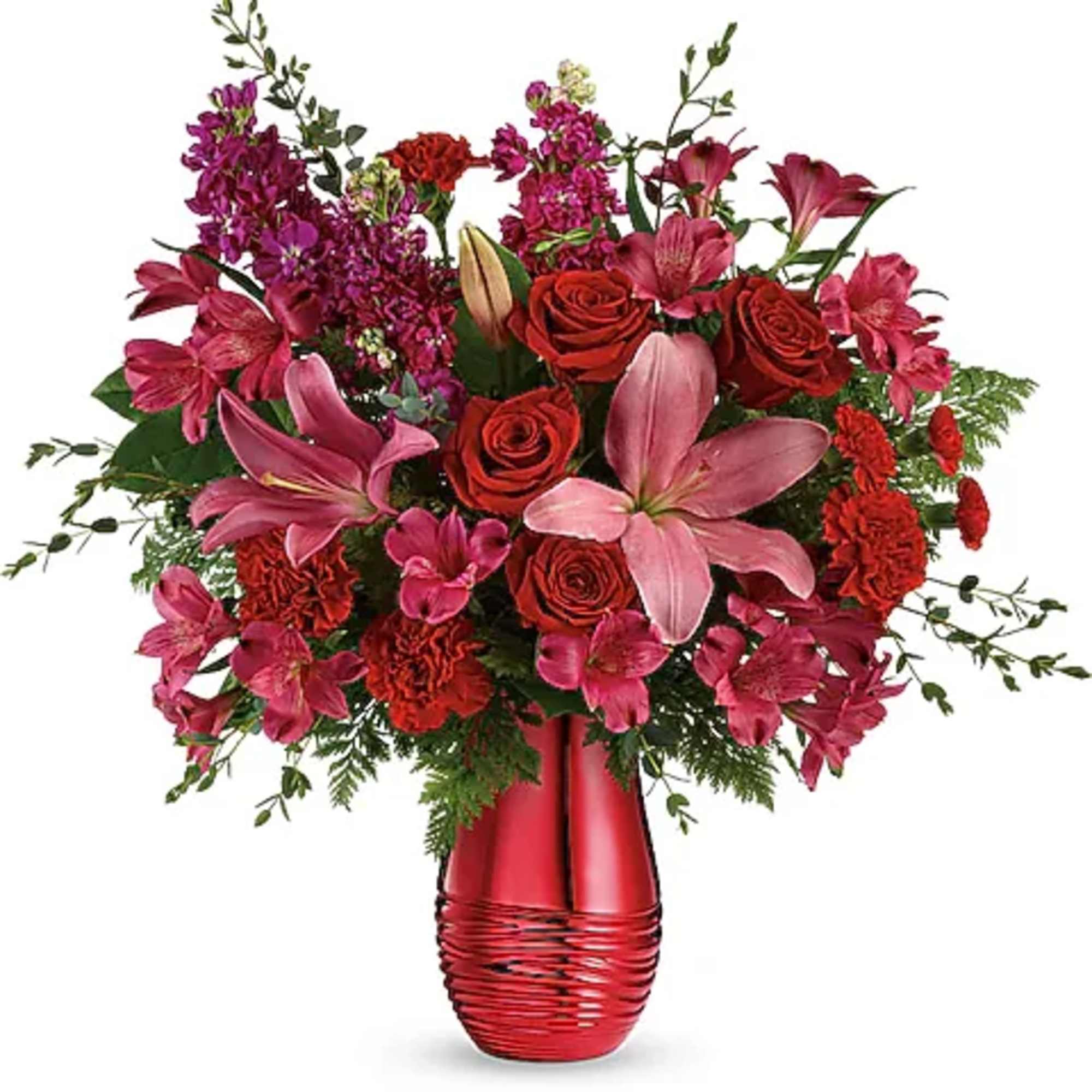 Red and pink mixed flower arrangement in a red vase
