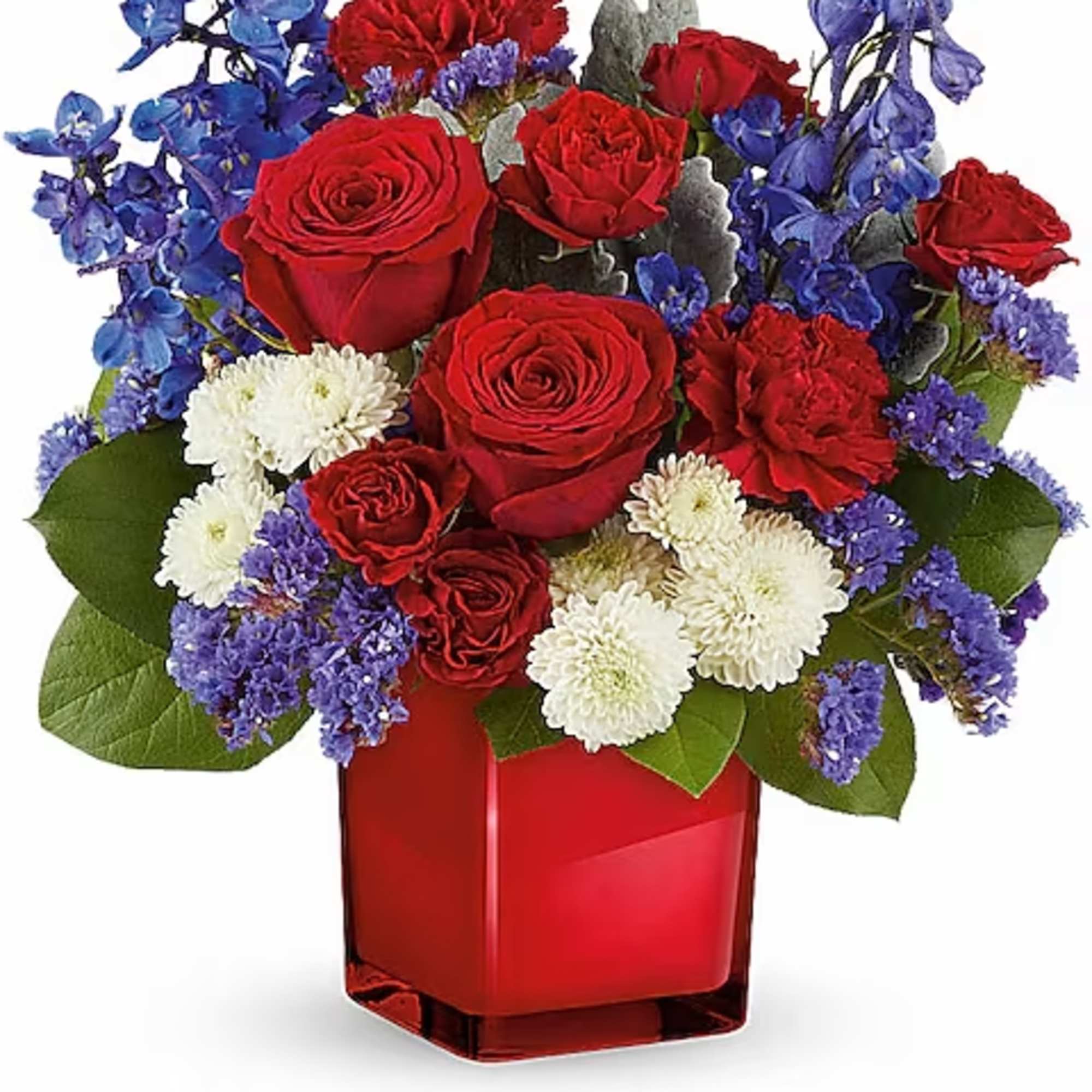 Red roses with blue flowers and white mums in a red glass vase