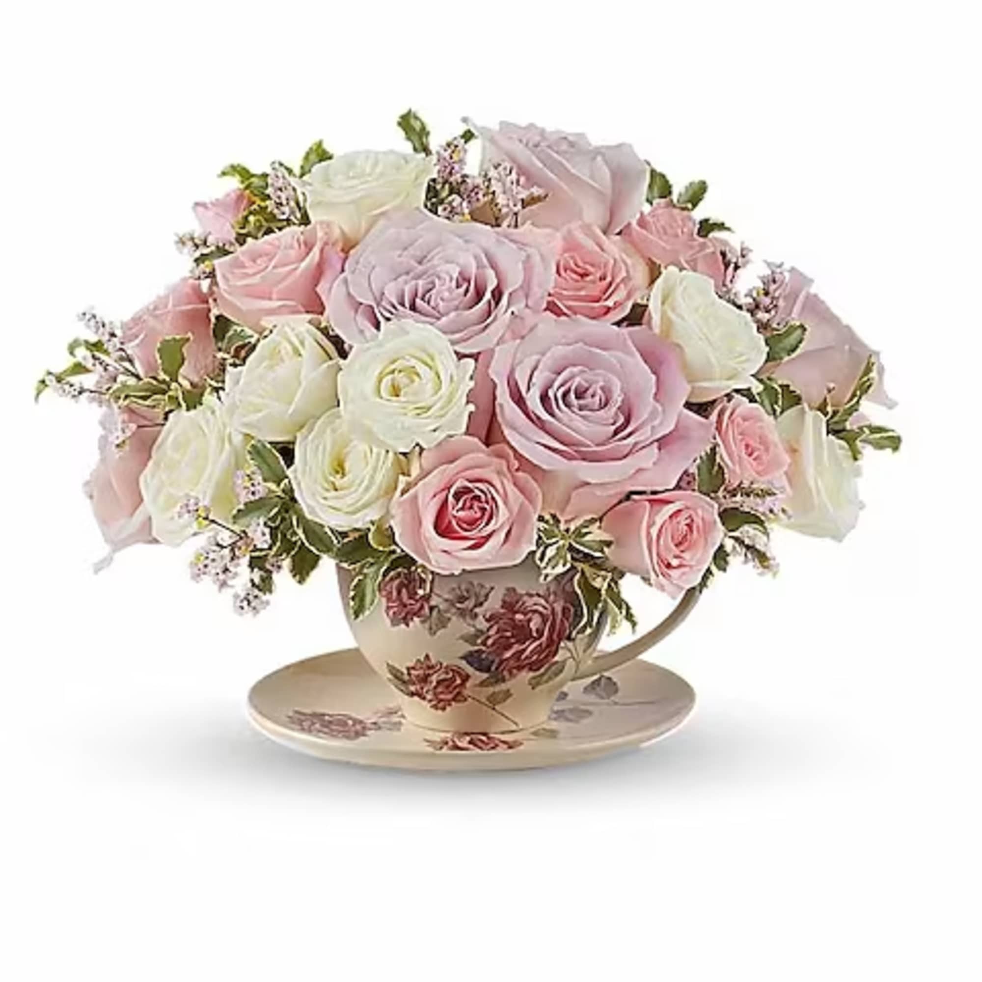 Pink and white rose bouquet in a floral teacup with saucer