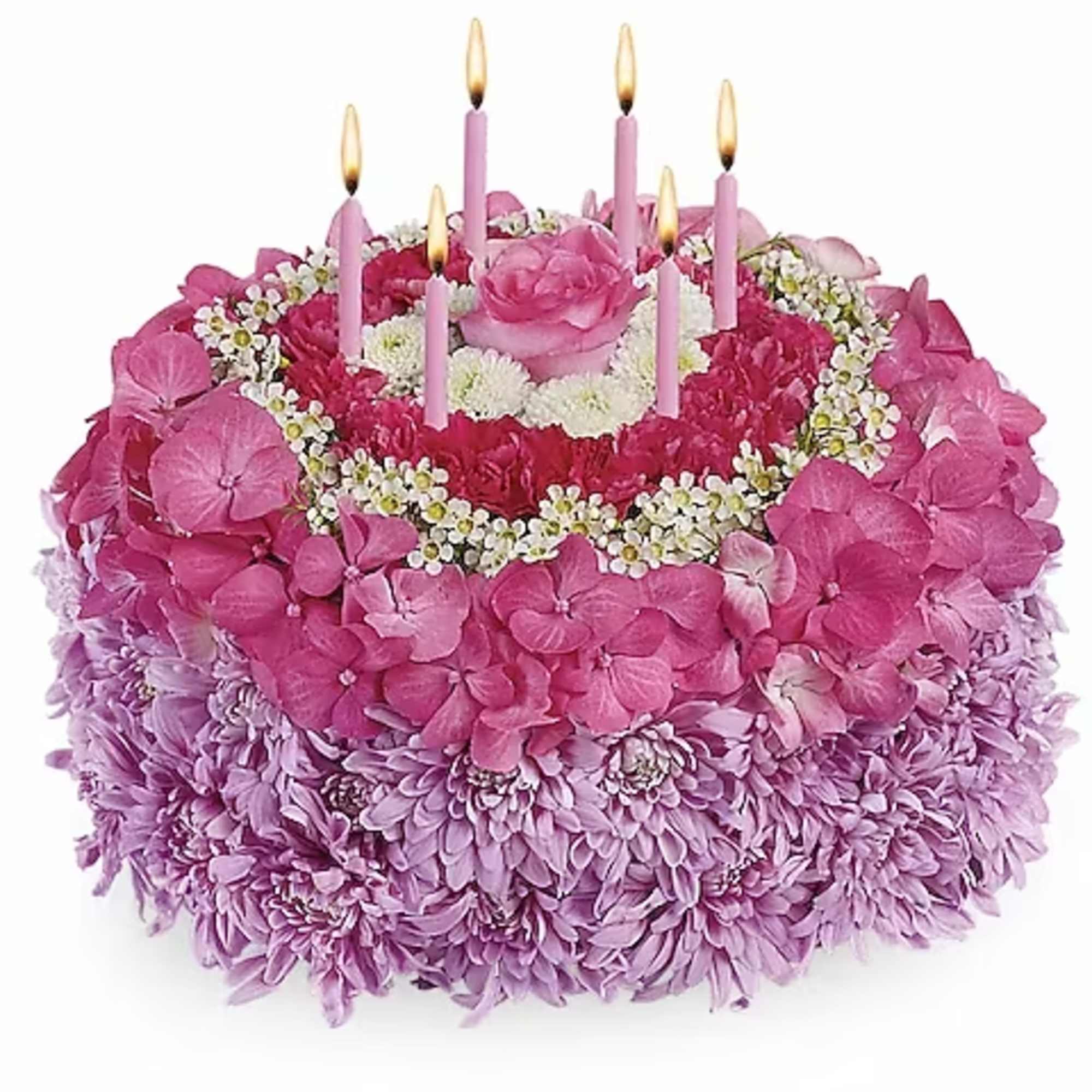 Pink floral cake with lit candle-shaped decorations