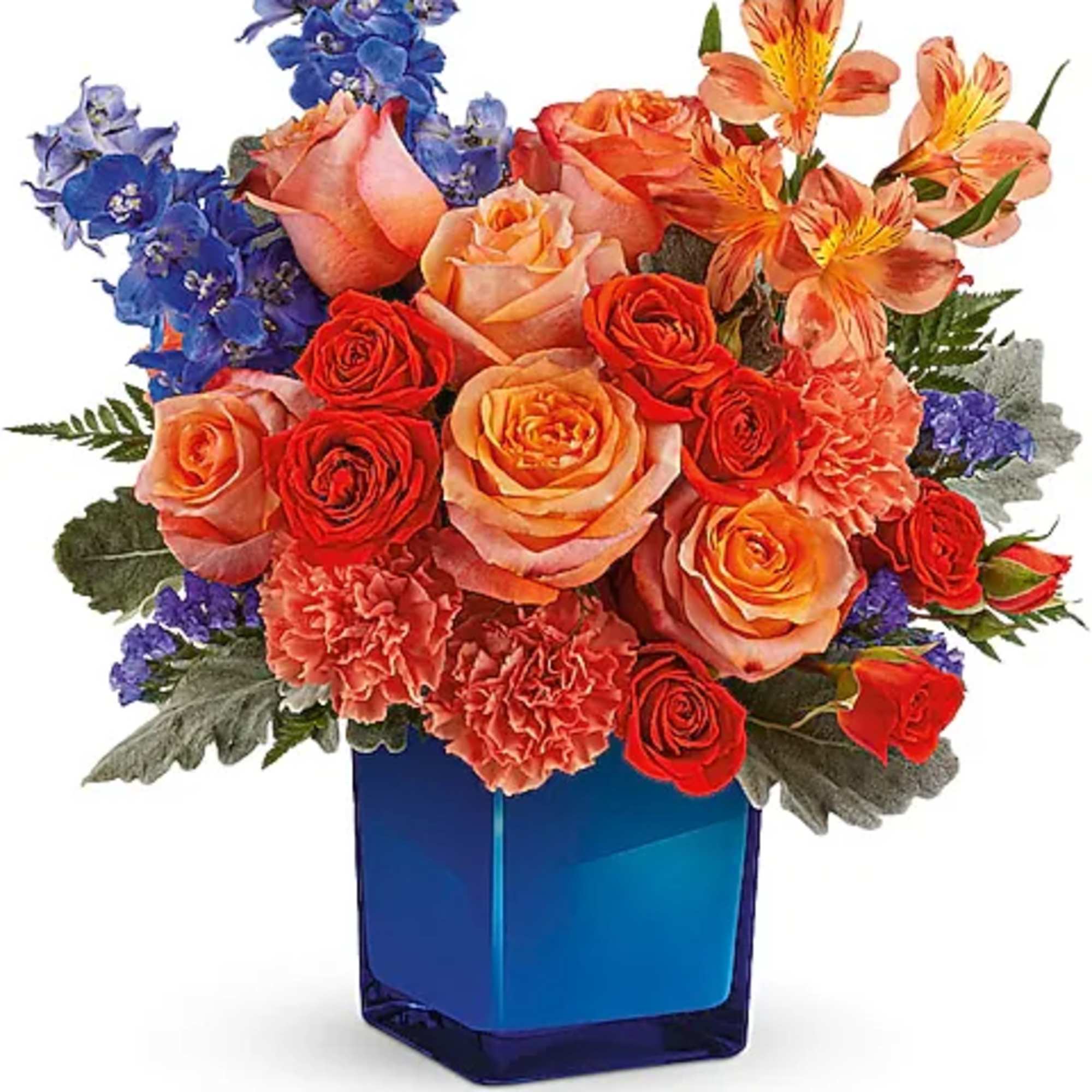Bouquet of roses, carnations, and blue flowers in a blue vase