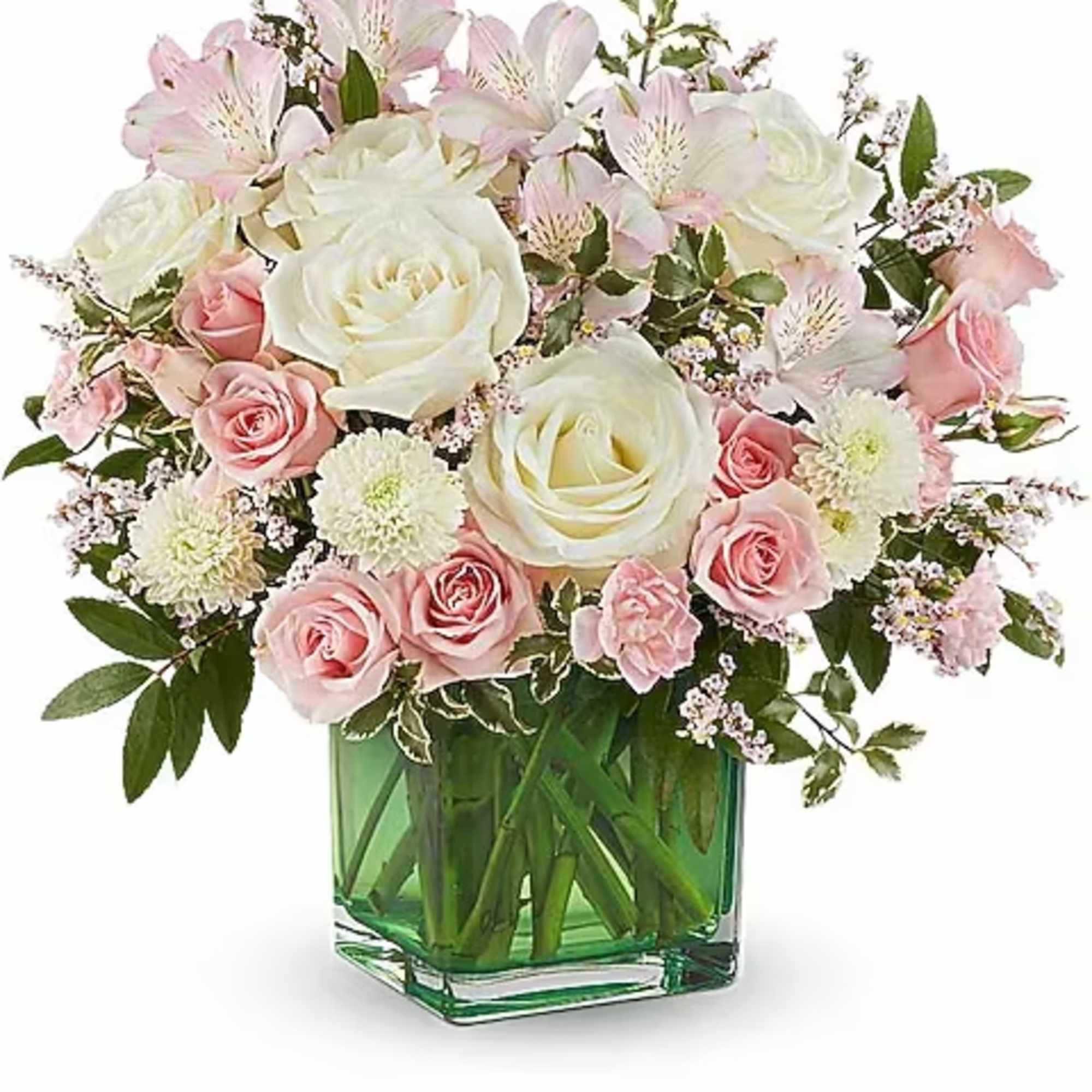 Pink and white rose bouquet in a green glass vase