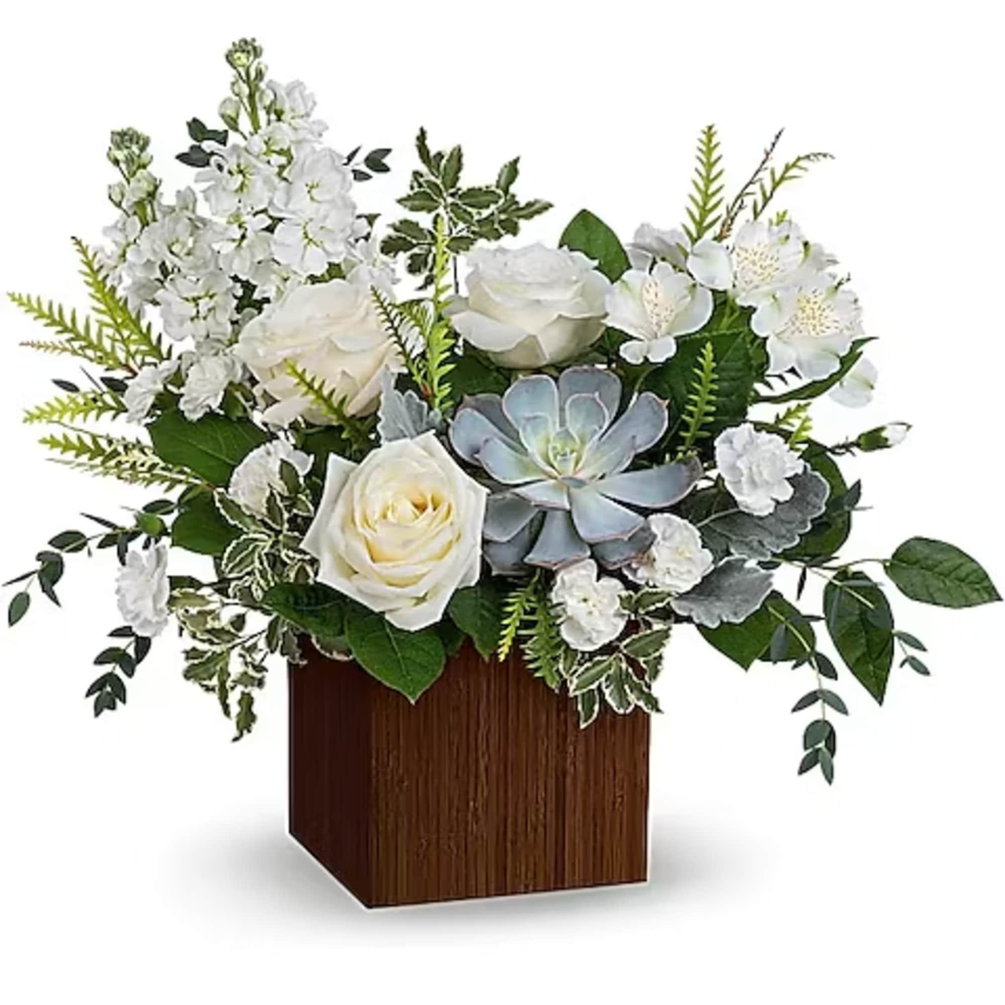White roses and mixed white flowers in a wooden cube vase