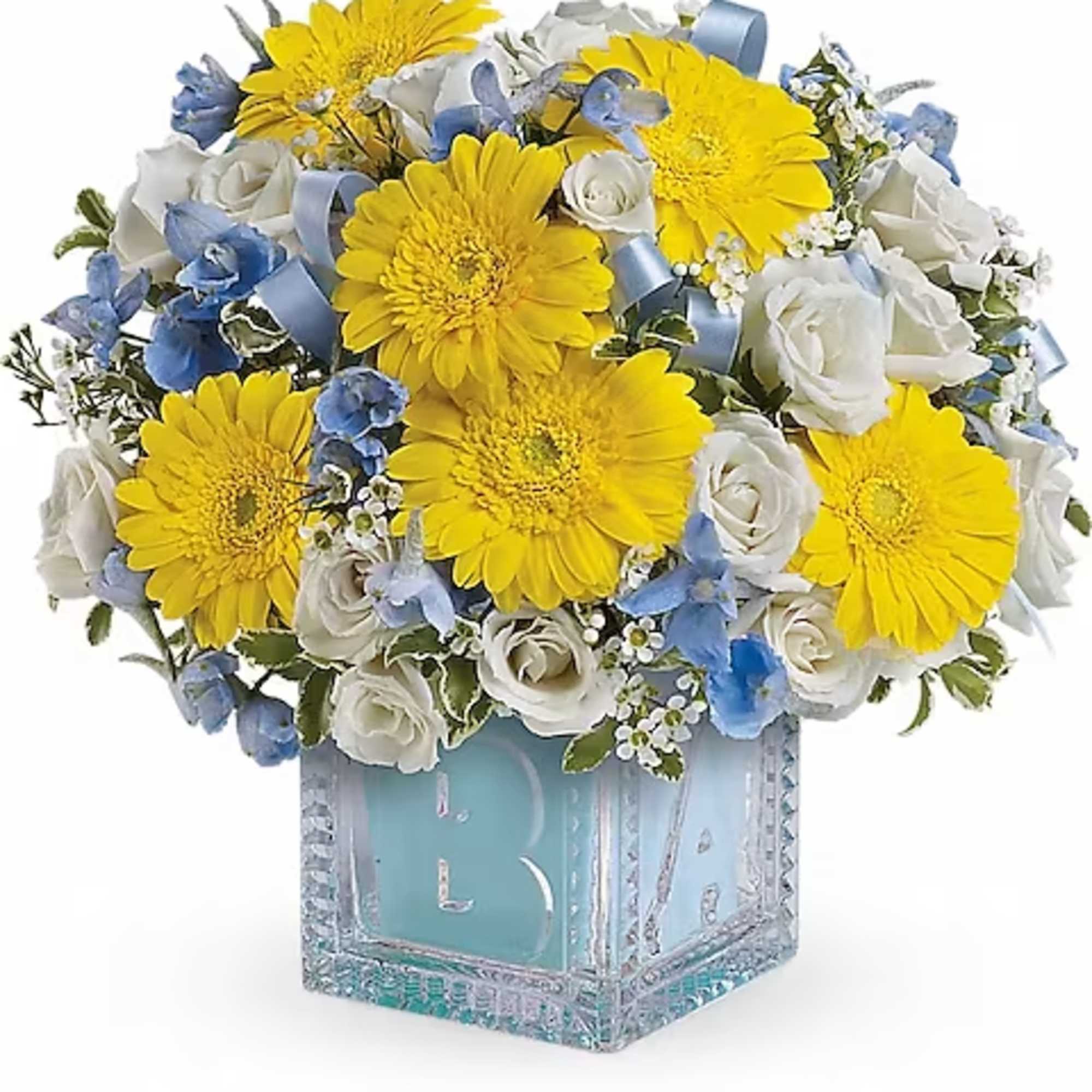 Yellow gerbera daisies and white roses in a glass vase
