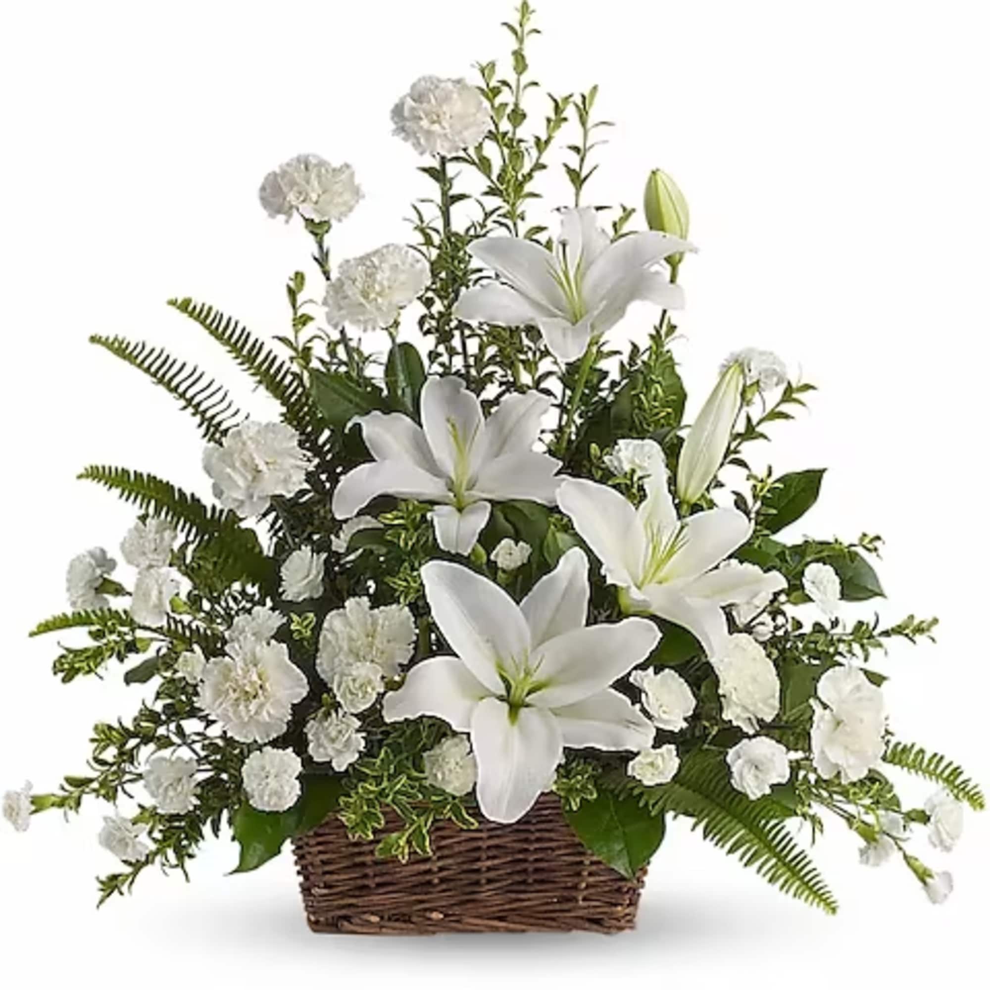 White lilies and carnations arranged in a wicker basket