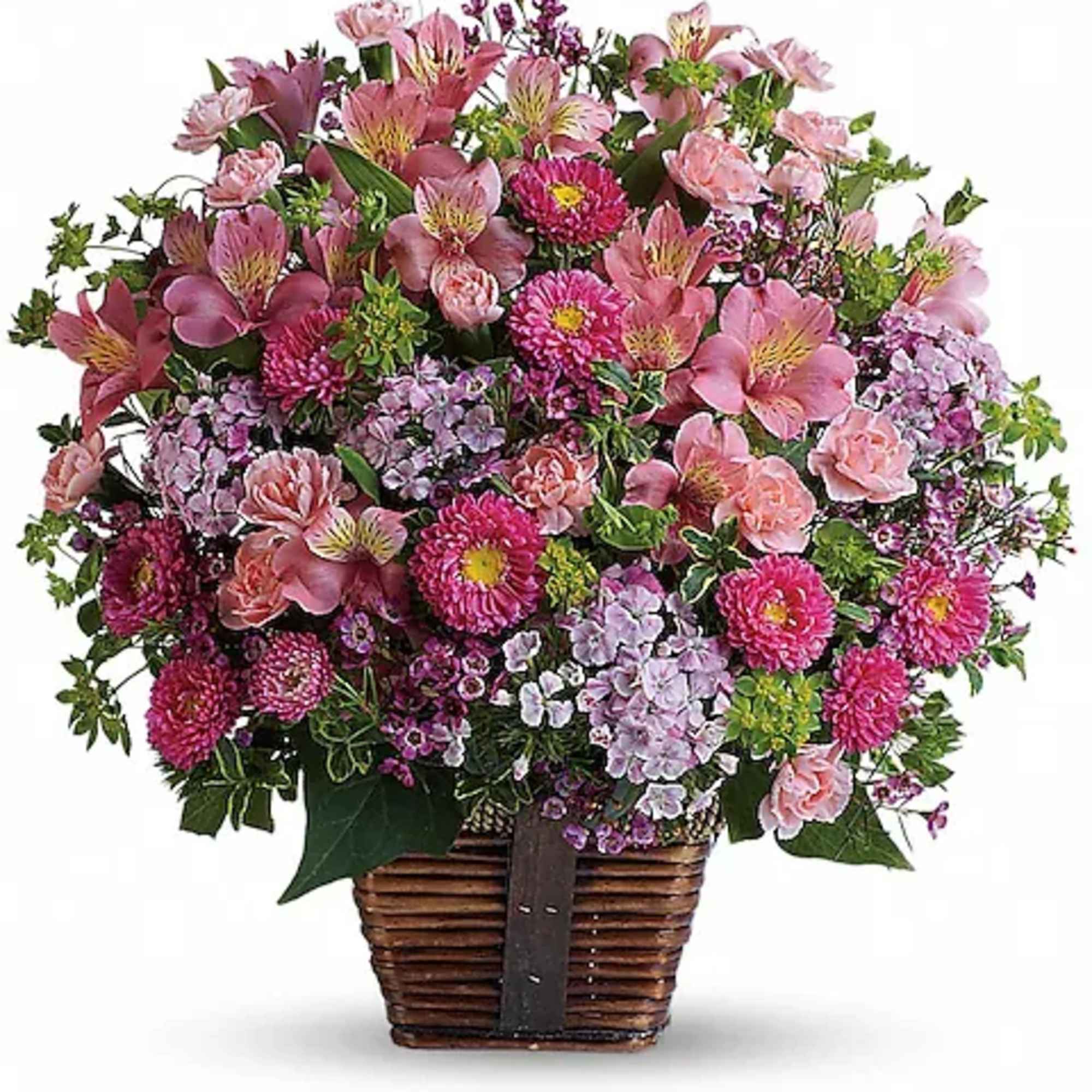 Pink mixed flower arrangement in a wicker basket