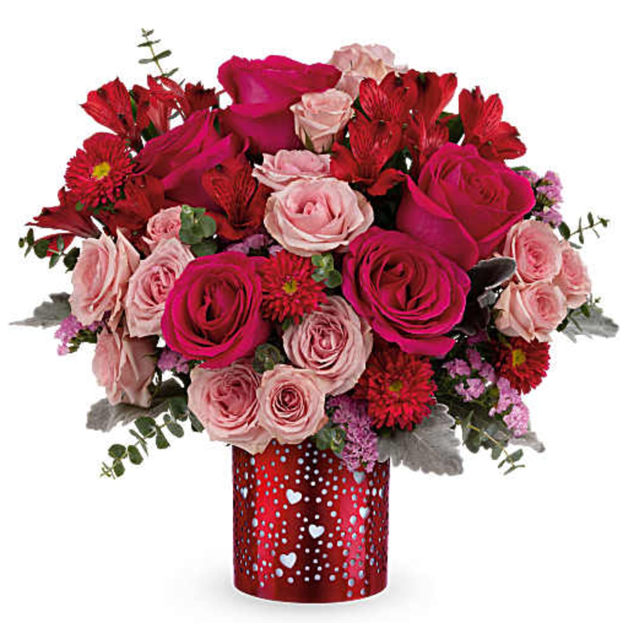 Pink and red rose bouquet in a heart-patterned red vase