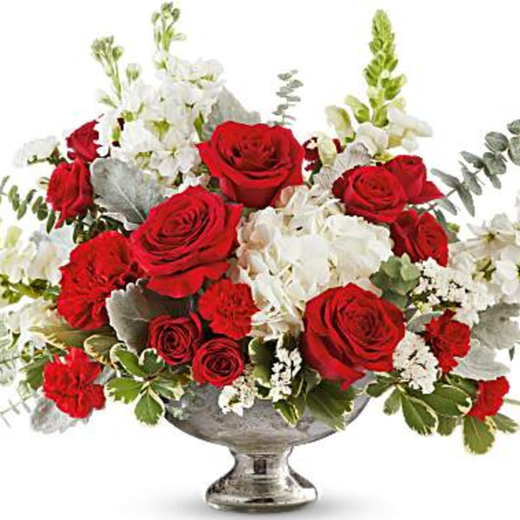 Red roses and white flowers in a silver pedestal vase