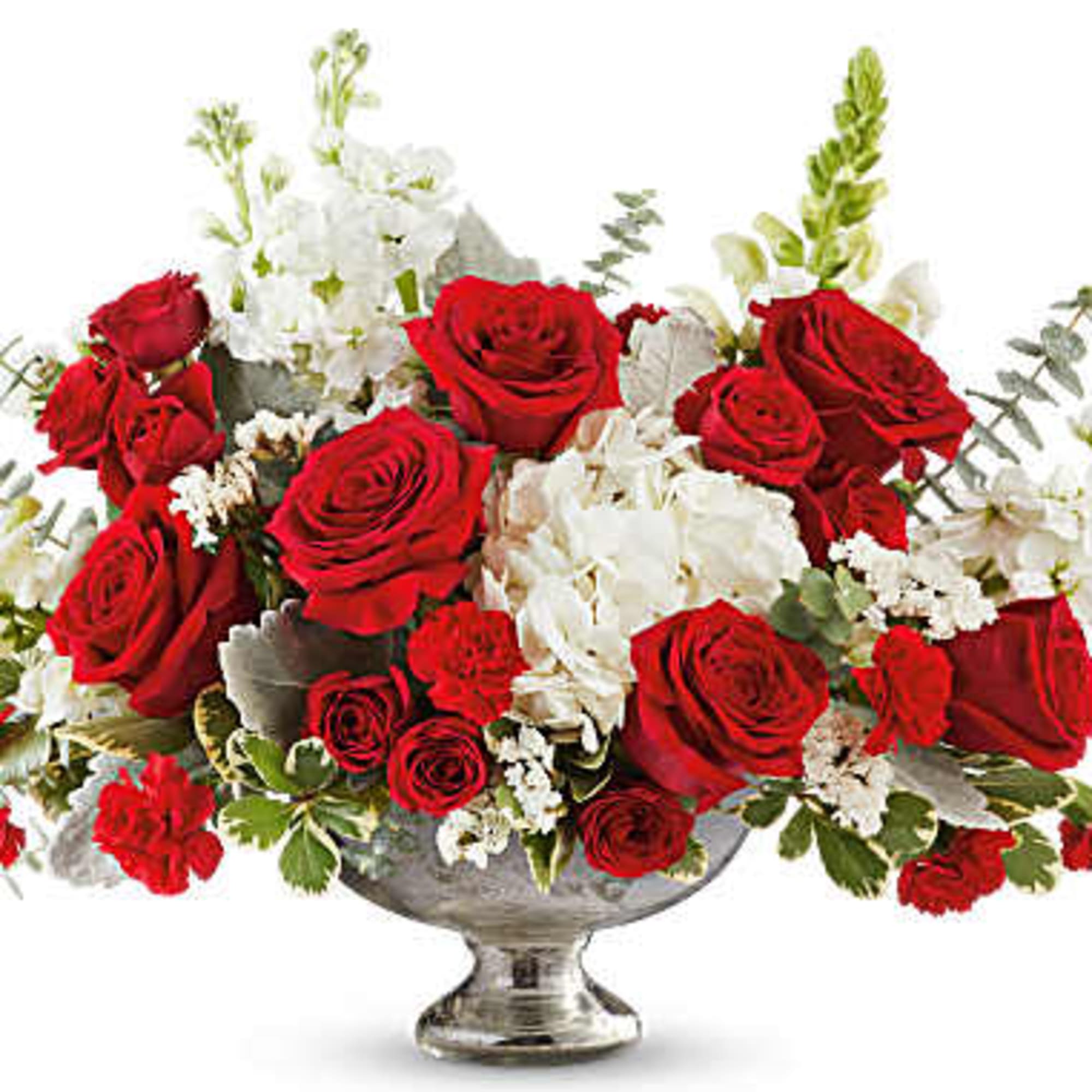 Red roses and white flowers arranged in a silver pedestal vase