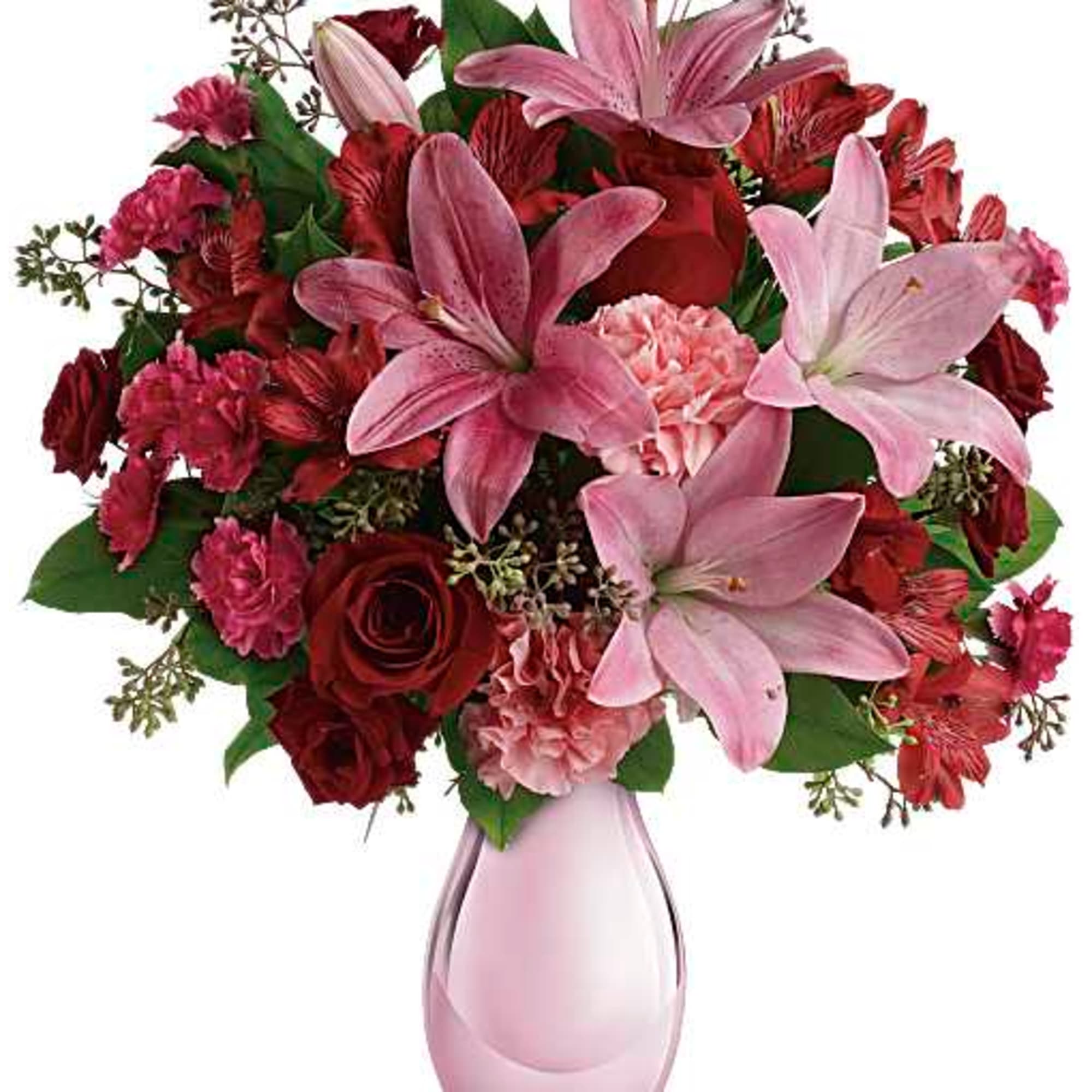 Pink lilies and red mixed flowers in a pink glass vase