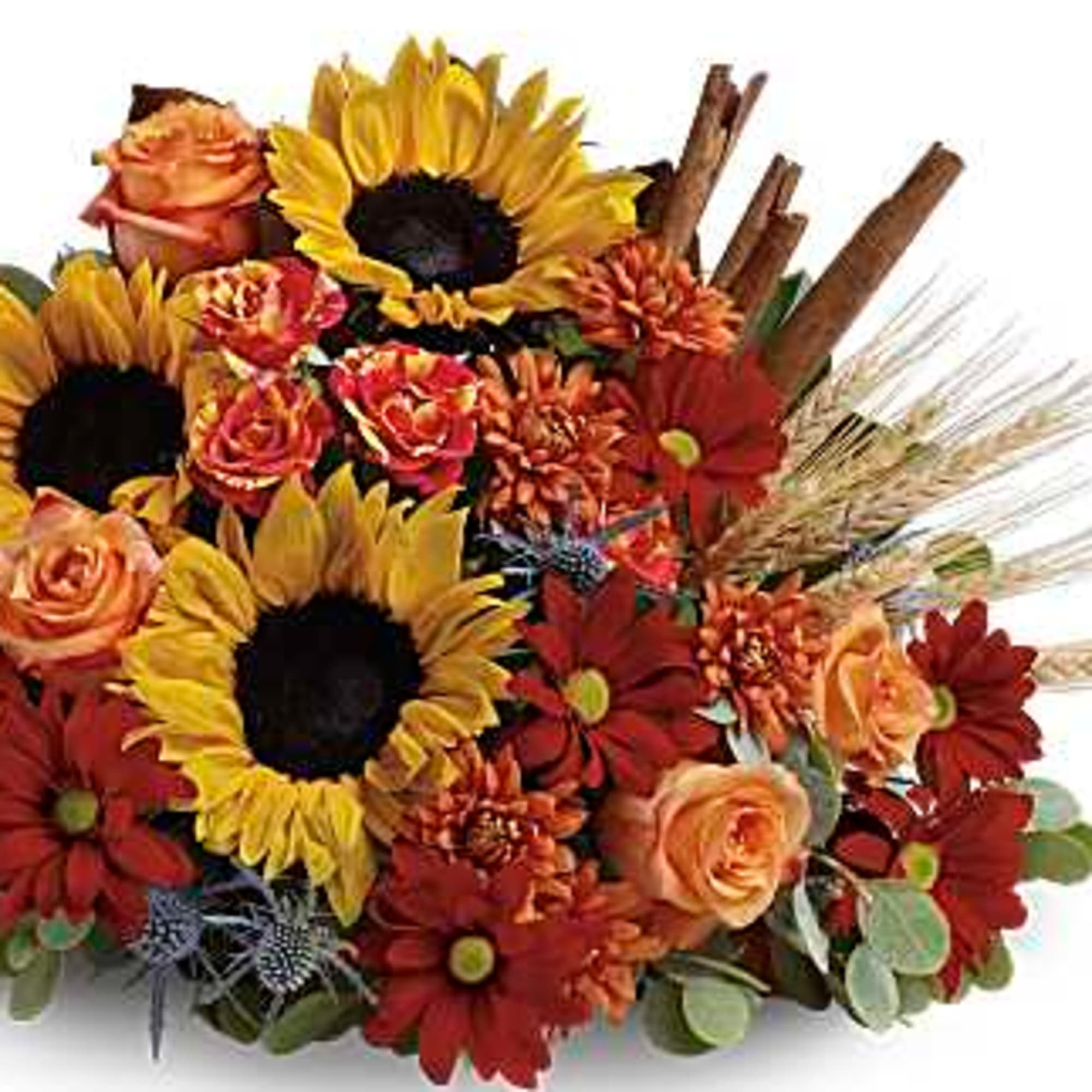 Sunflowers and orange roses arranged with red mums in a wicker cornucopia
