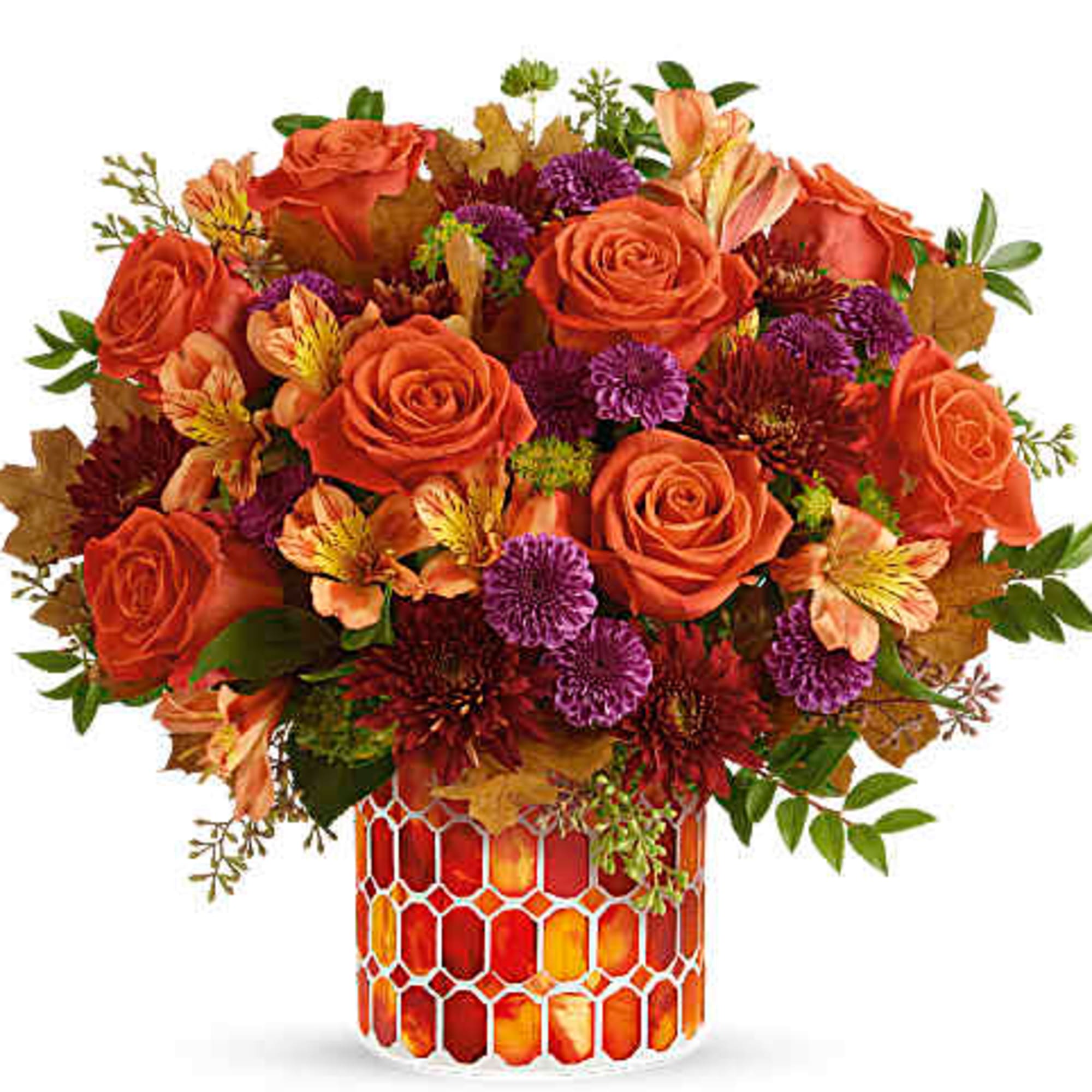 Orange roses and purple flowers in a patterned glass vase