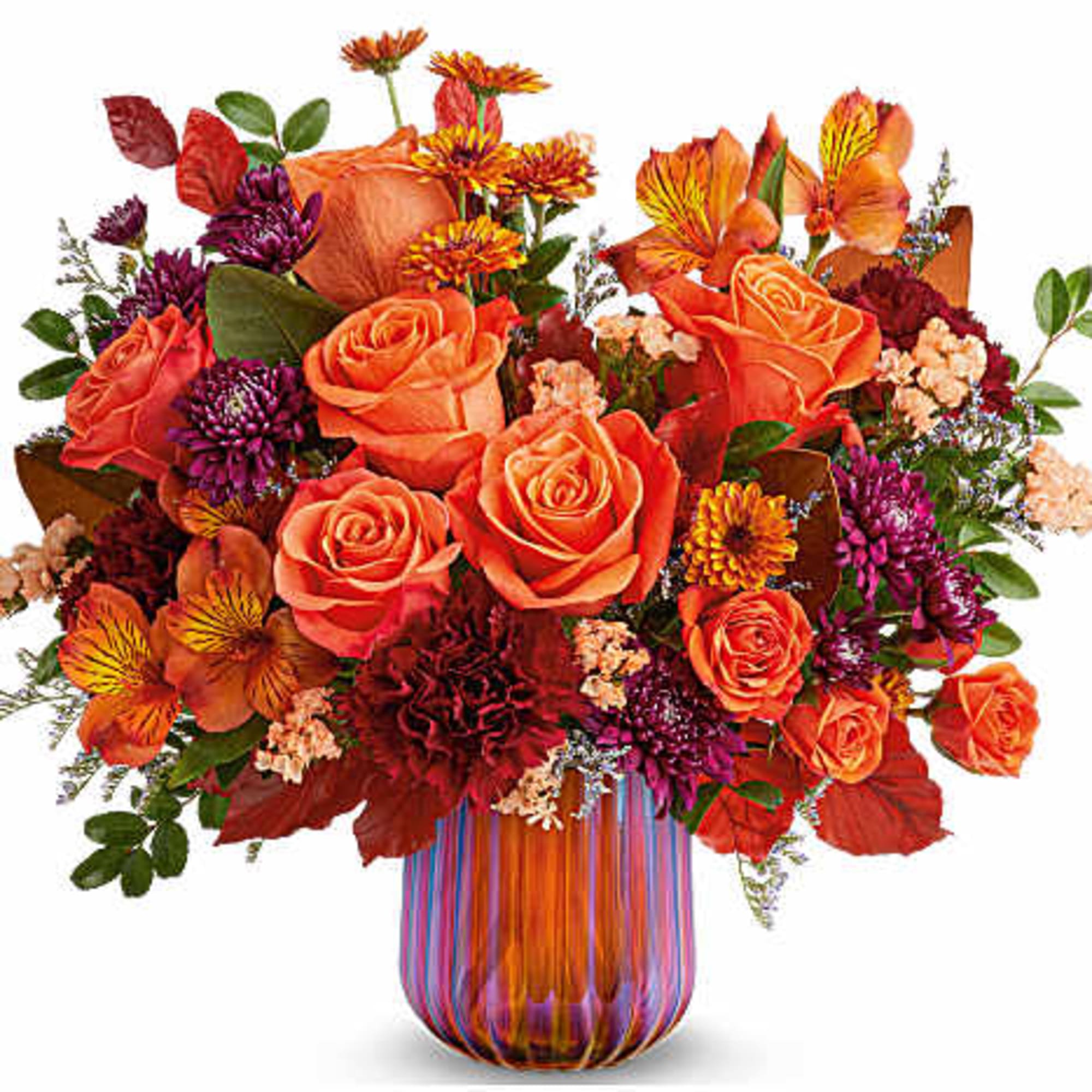 Orange and purple mixed bouquet in a striped glass vase