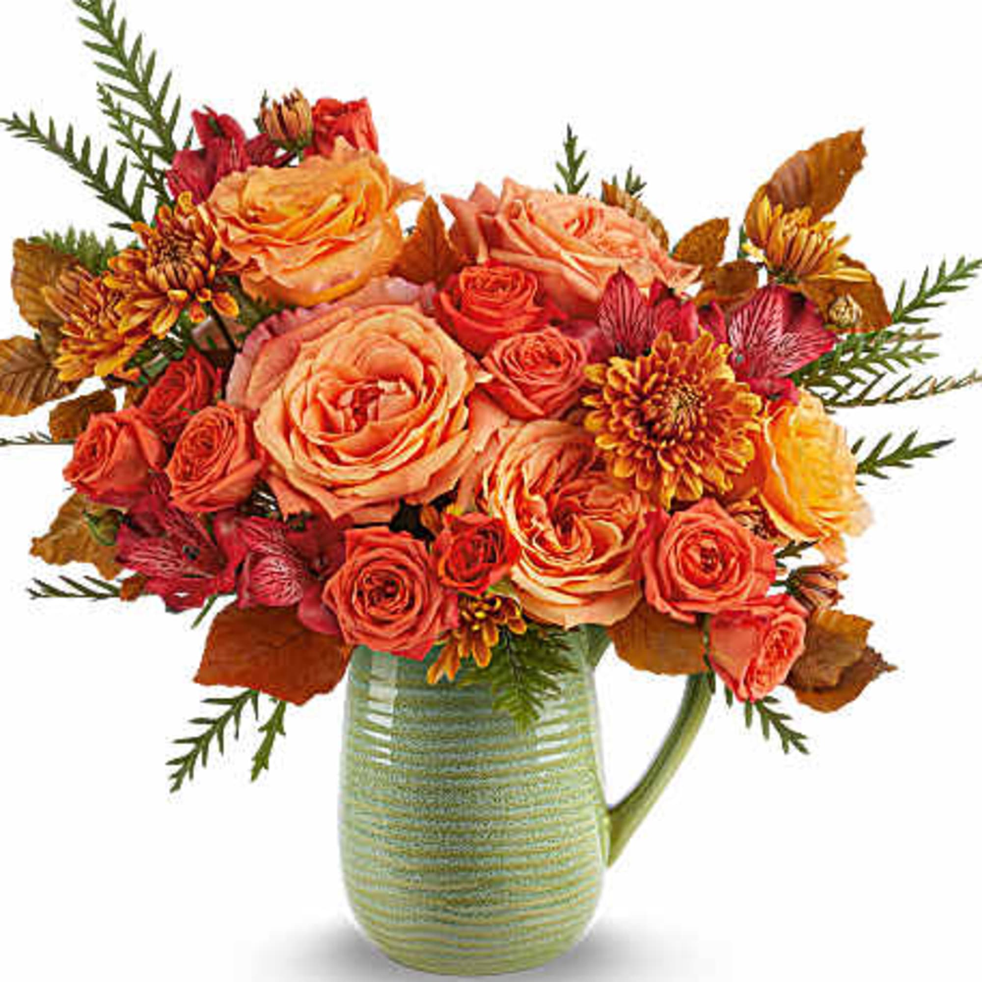 Orange and coral roses with mums in a green ceramic pitcher