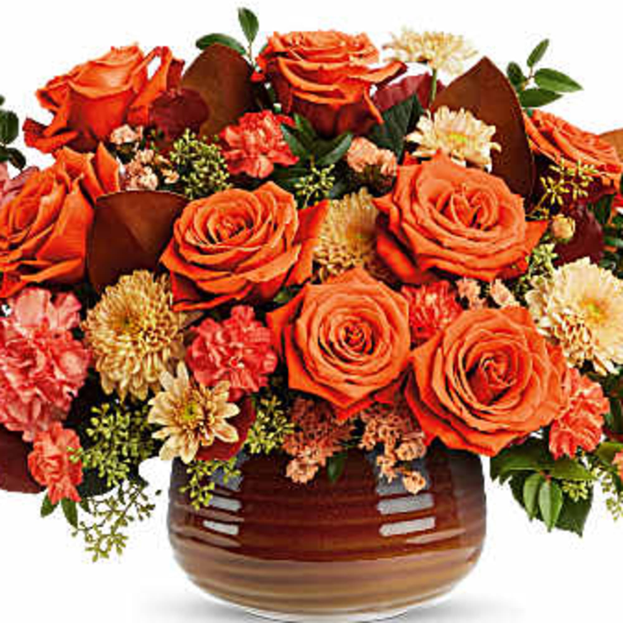 Orange roses and mixed flowers arranged in a brown glass vase