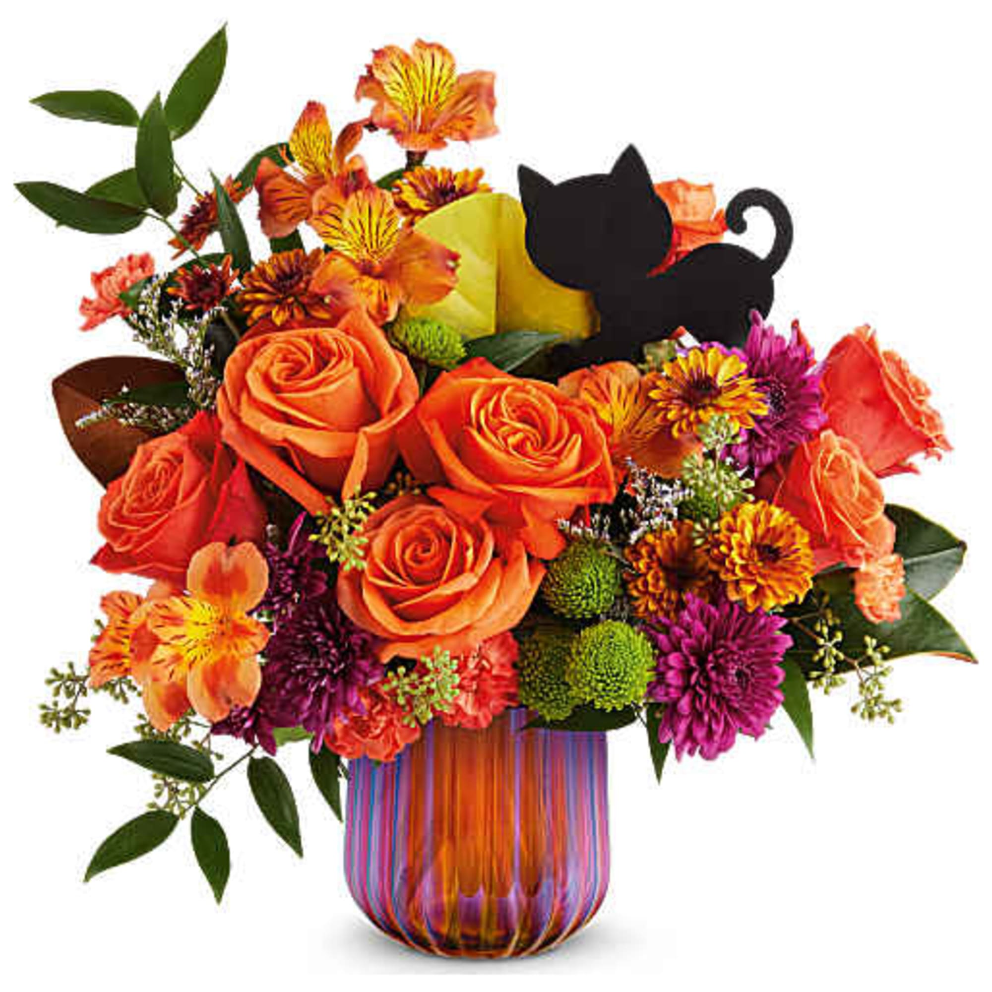 Orange roses and mixed flowers in a striped glass vase with a black cat pick