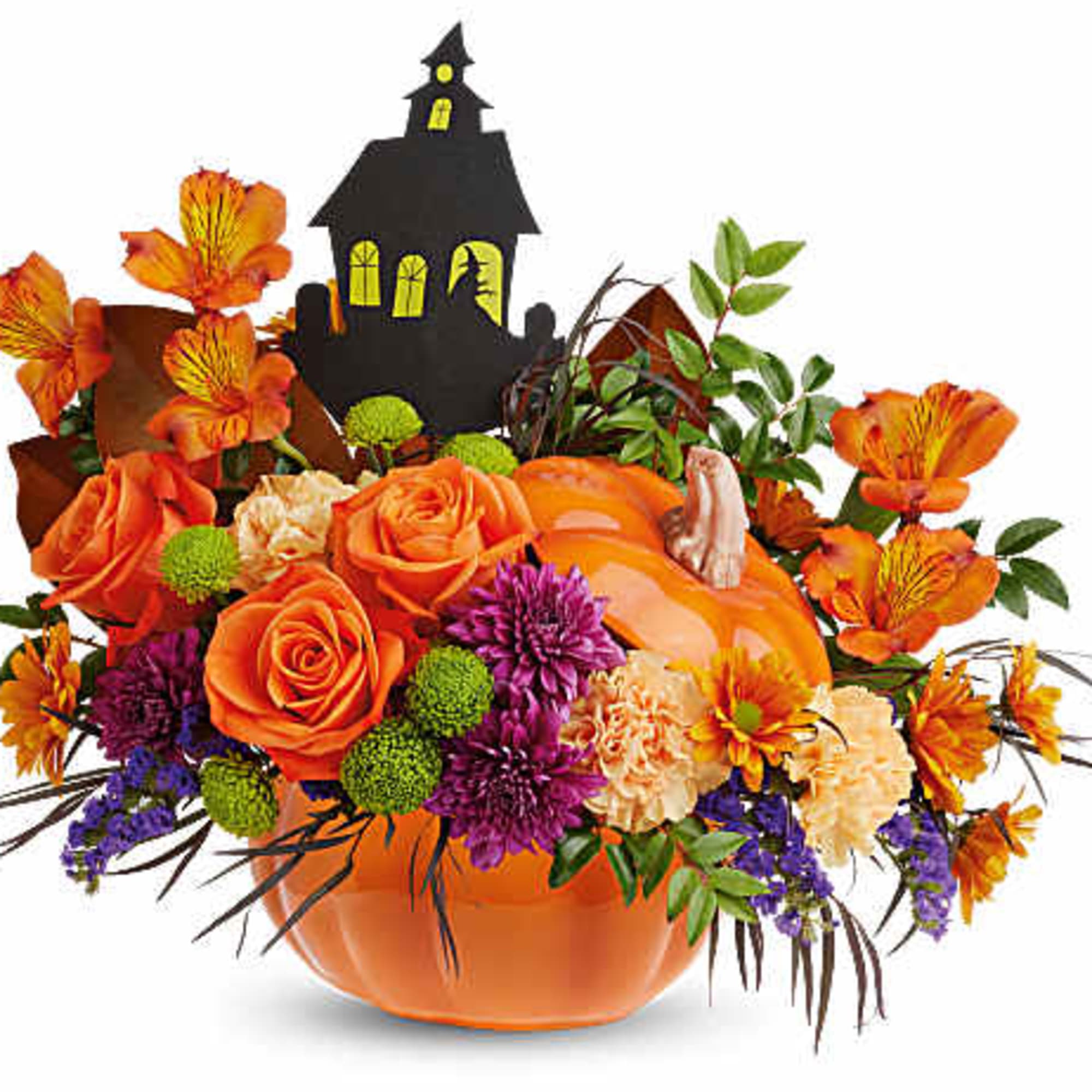 Orange floral arrangement in a pumpkin container with a haunted house topper