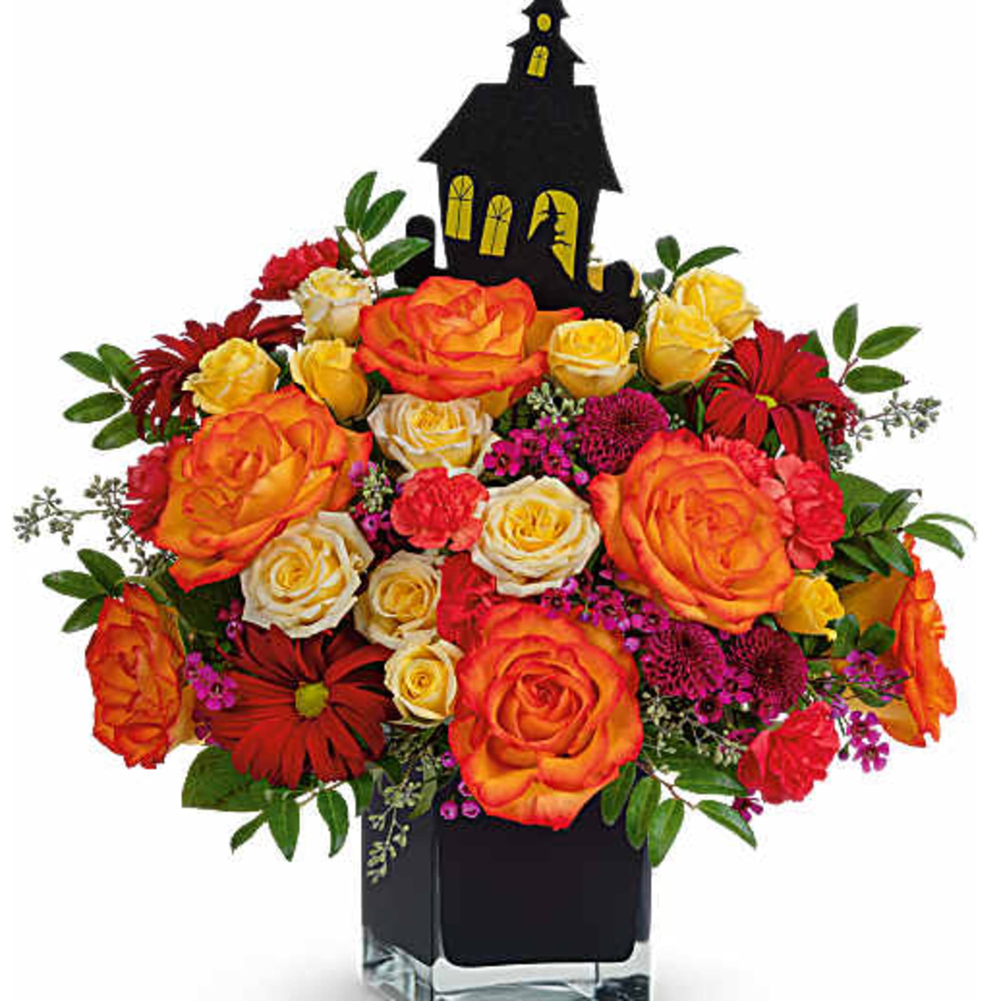 Orange and yellow roses in a black vase with a Halloween house topper
