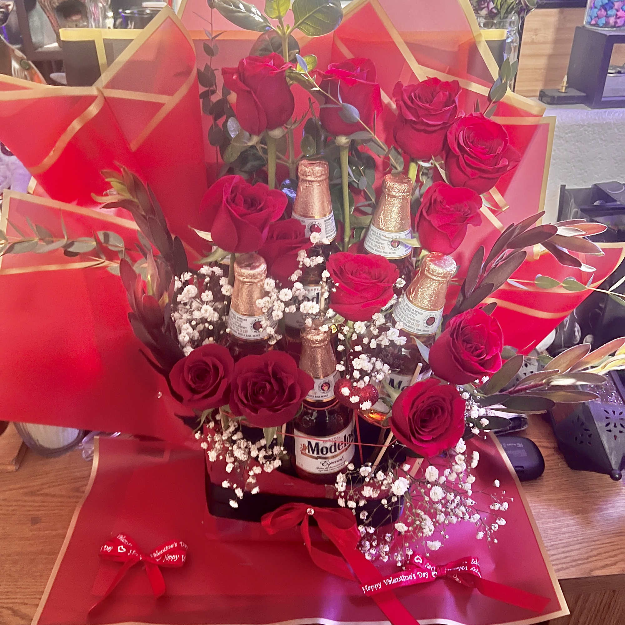 Bouquet of red roses with beer bottles and red wrapping