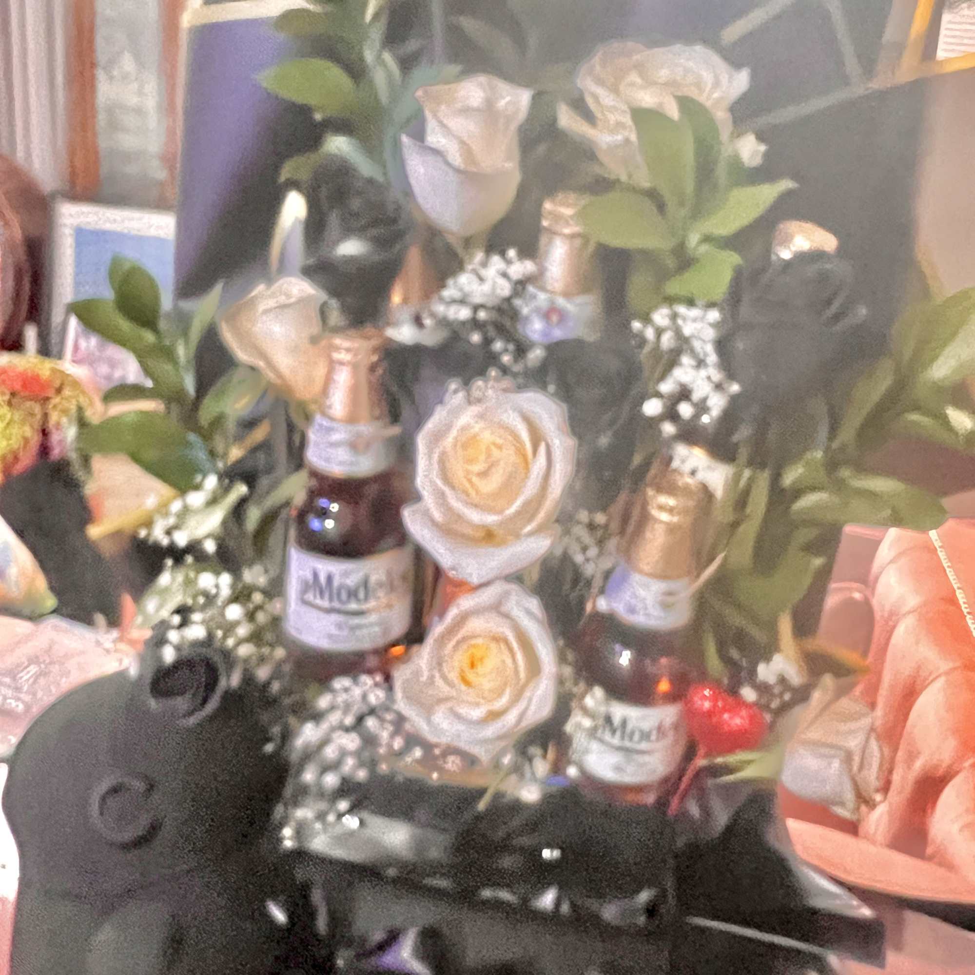 Bouquet with roses and beer bottles arranged in a black wrap