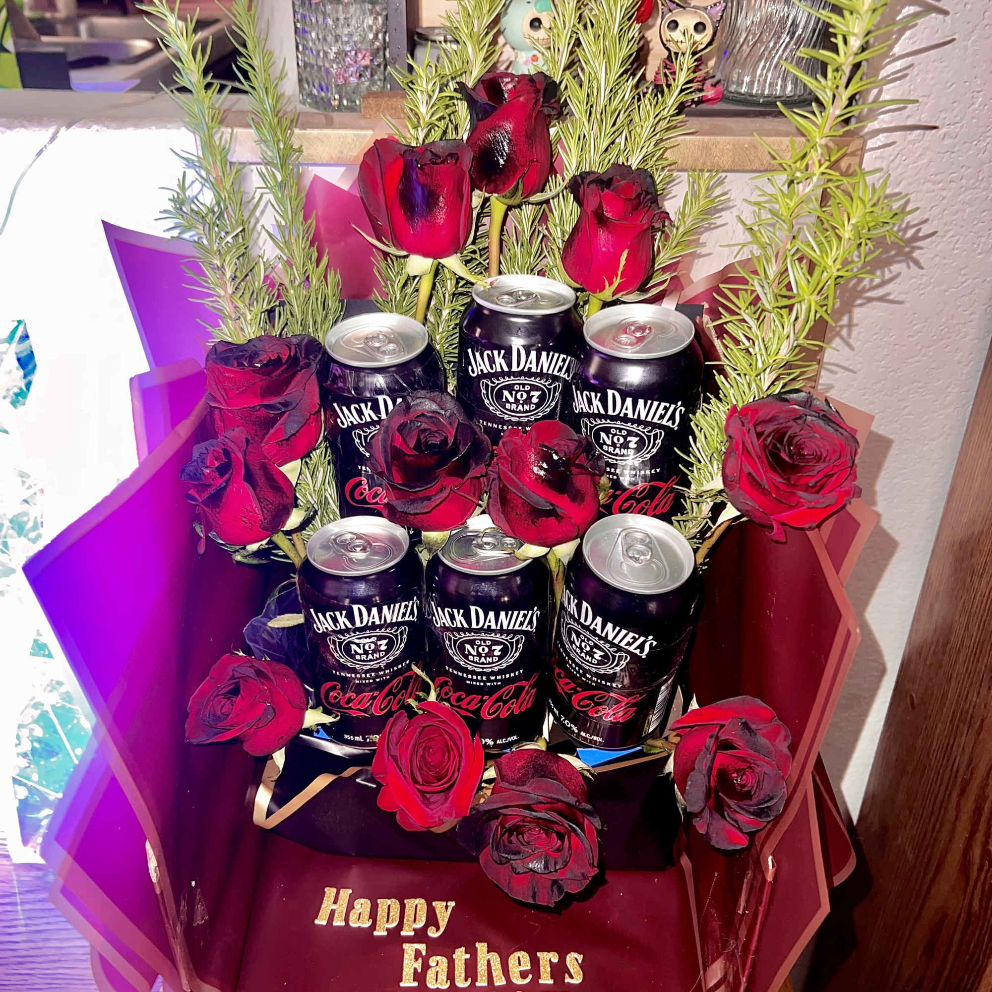 Bouquet of red roses with Jack Daniel's Coca-Cola cans in a gift box