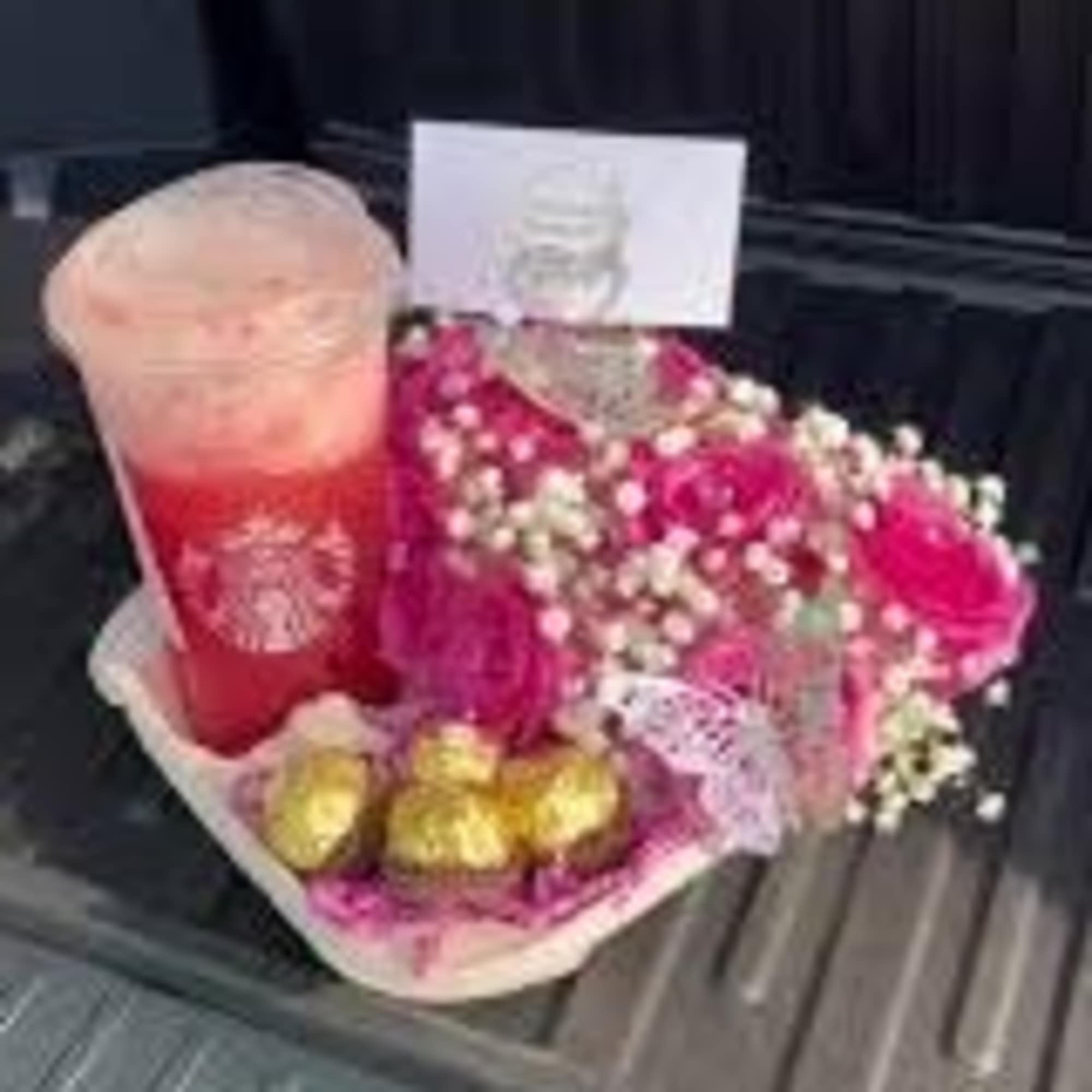 Pink flower bouquet with a Starbucks drink and chocolates in a gift tray