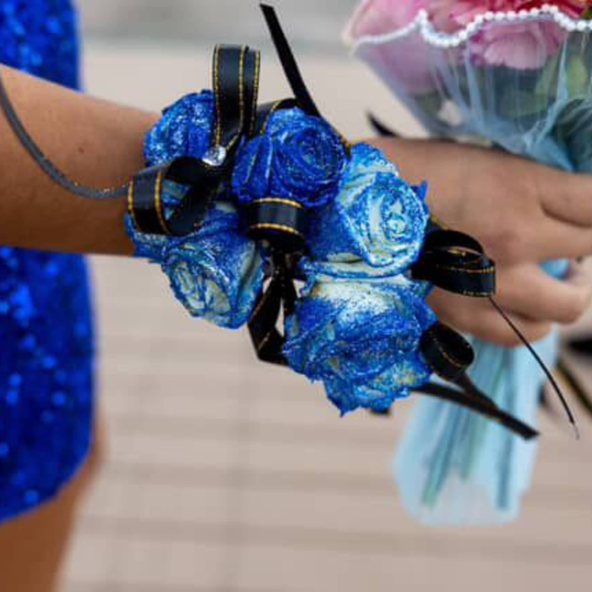 Blue rose wrist corsage with black ribbon ties