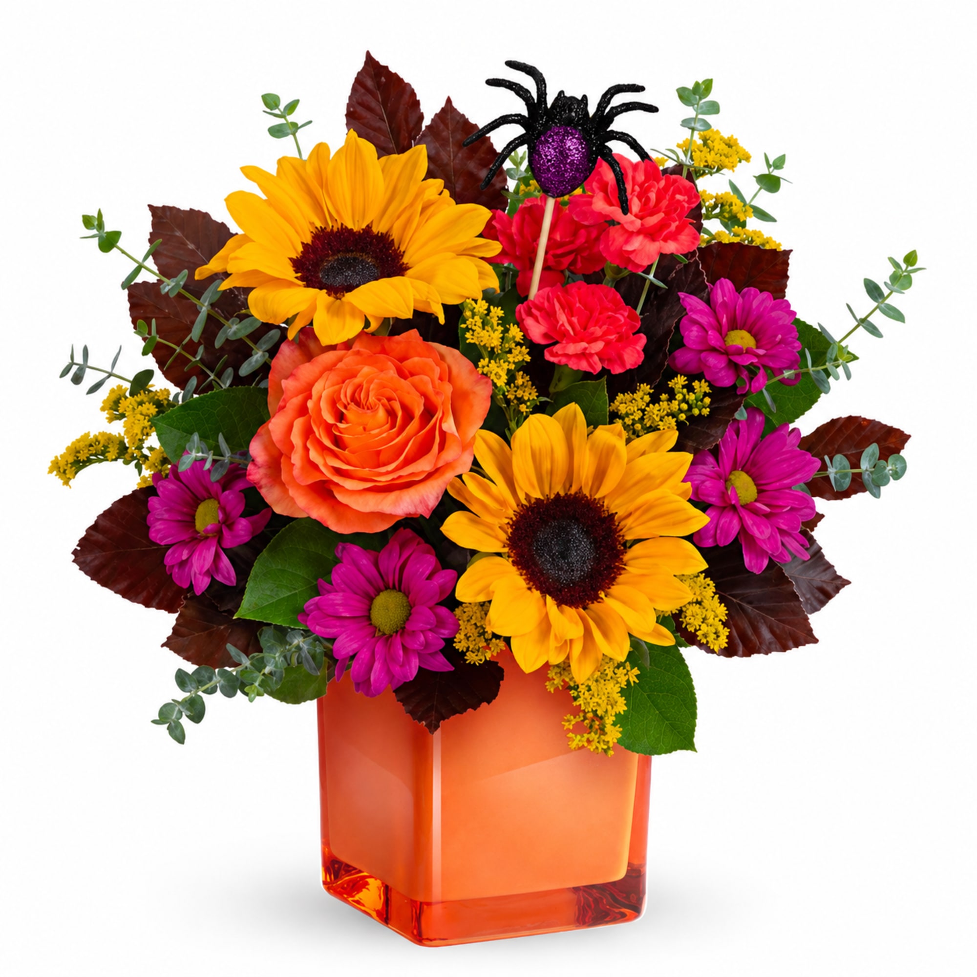 Mixed bouquet of sunflowers, roses, and daisies in an orange glass vase