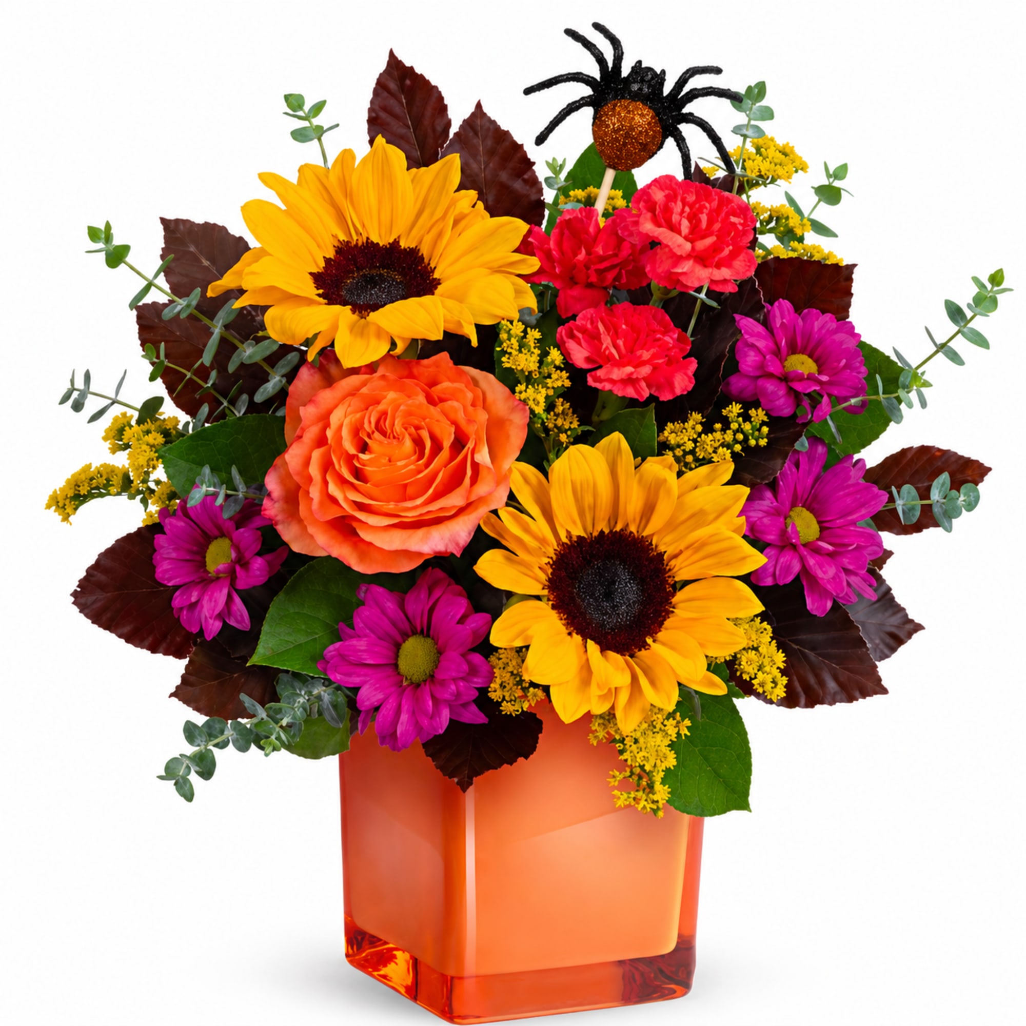 Bright mixed bouquet in an orange glass vase with sunflowers, roses, and daisies