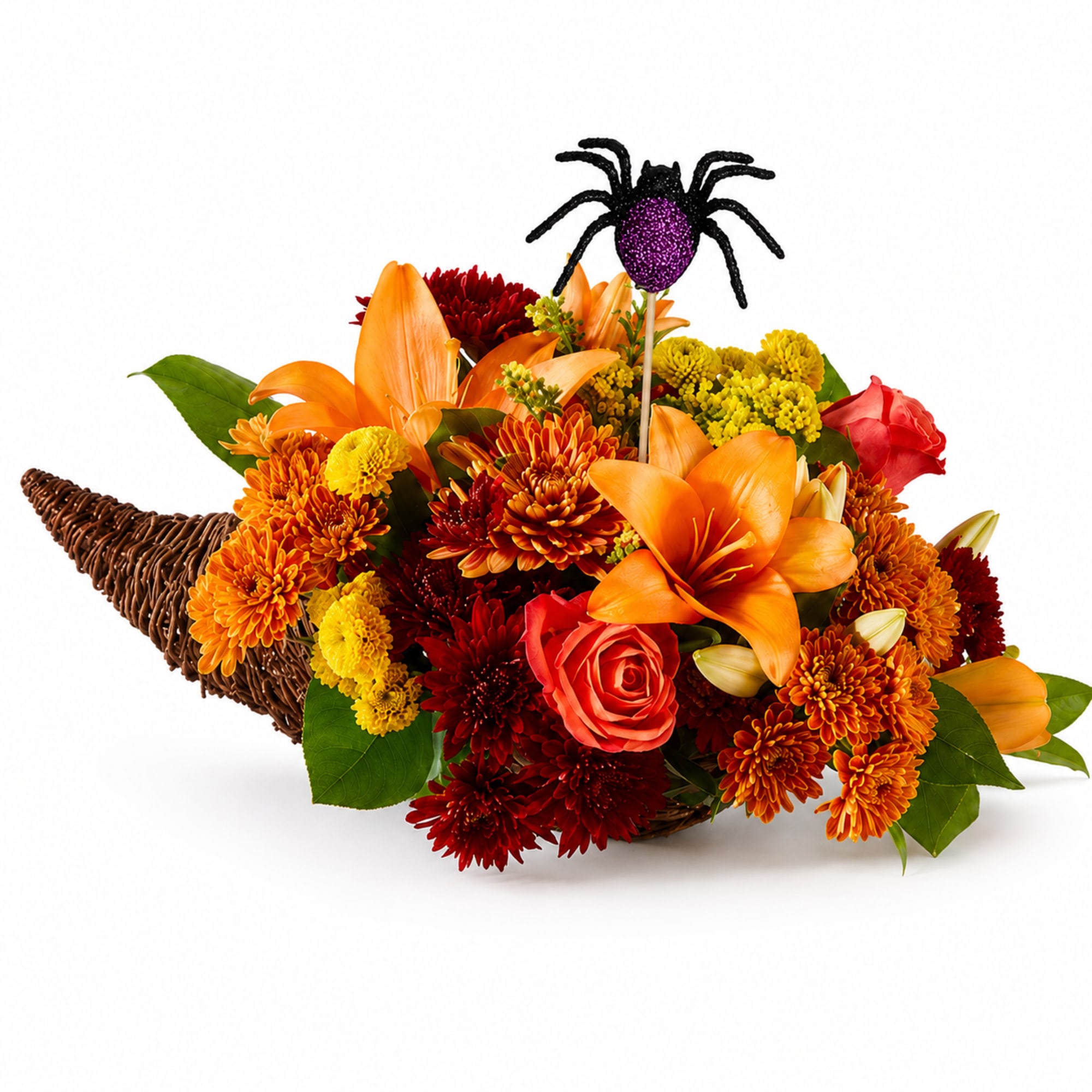 Orange and red flower arrangement in a wicker basket with a spider pick