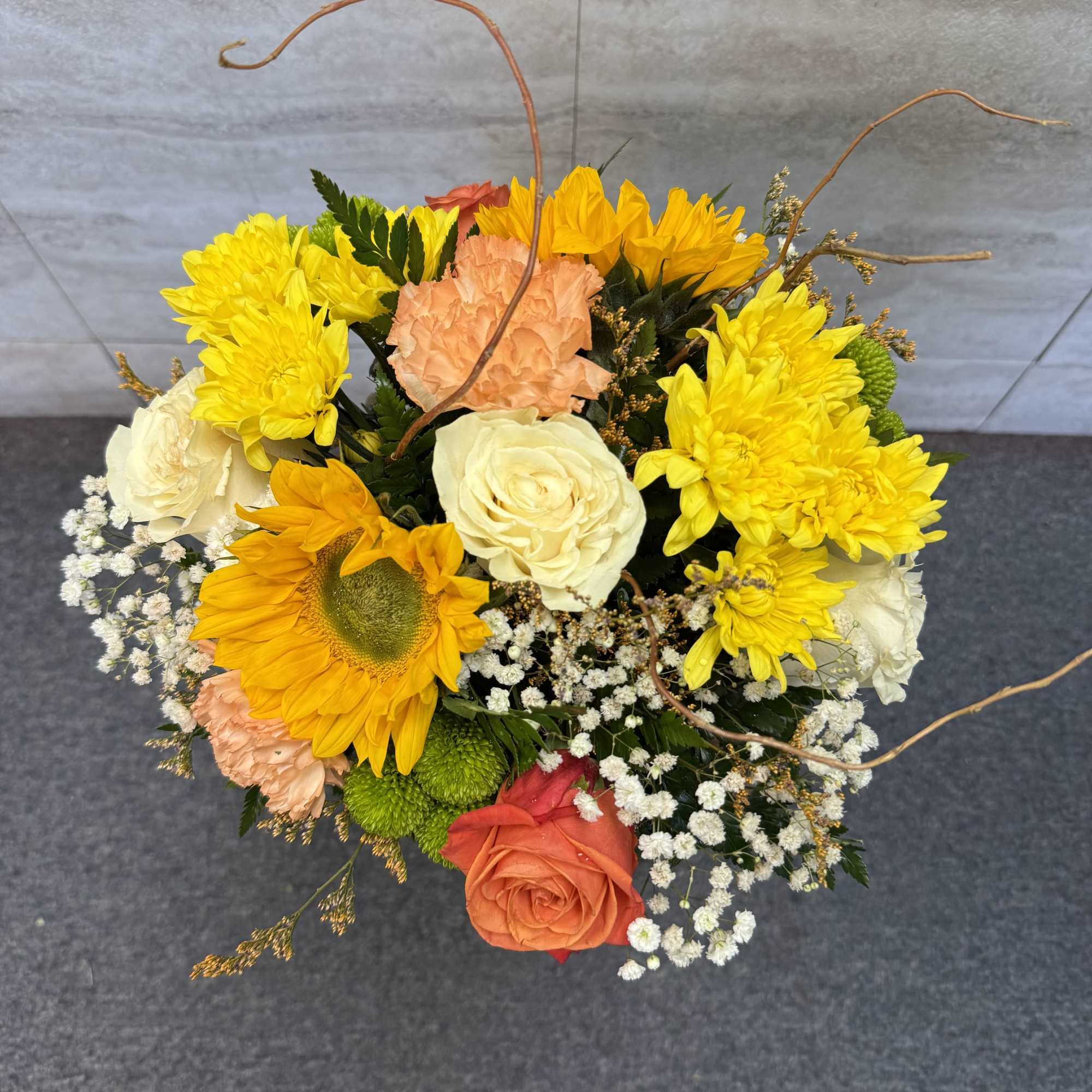 Mixed bouquet with yellow sunflowers, roses, and chrysanthemums