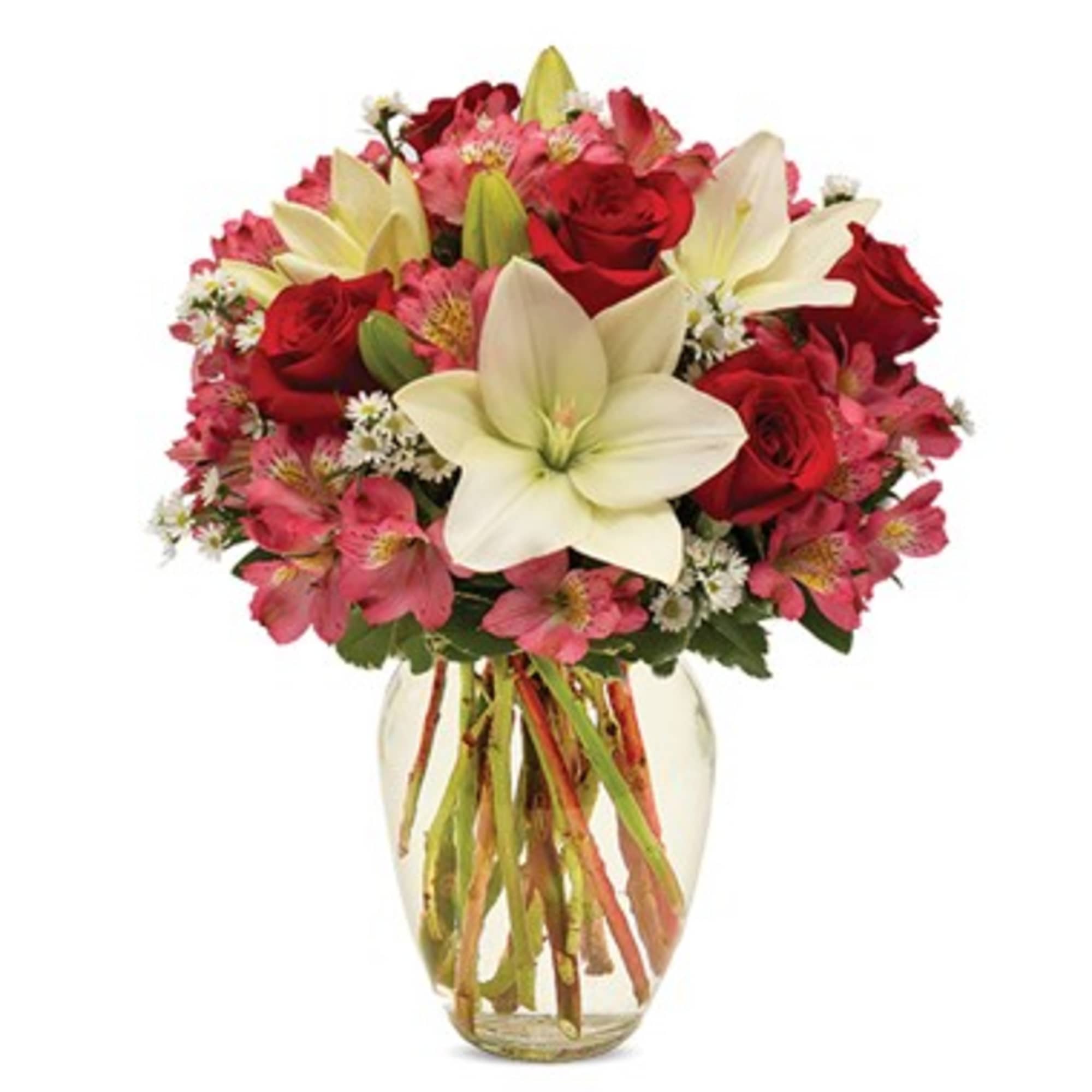 Bouquet of red roses and pink flowers in a clear glass vase
