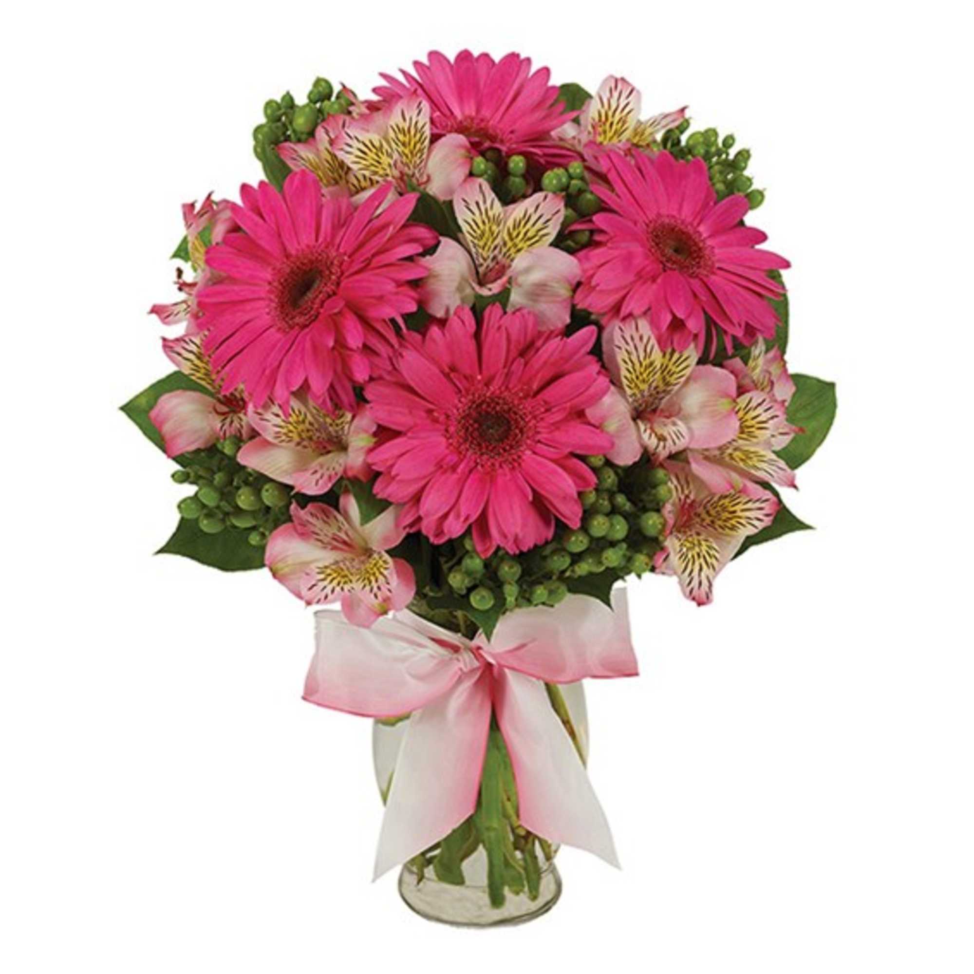 Pink gerbera daisies and alstroemeria in a glass vase with a pink ribbon