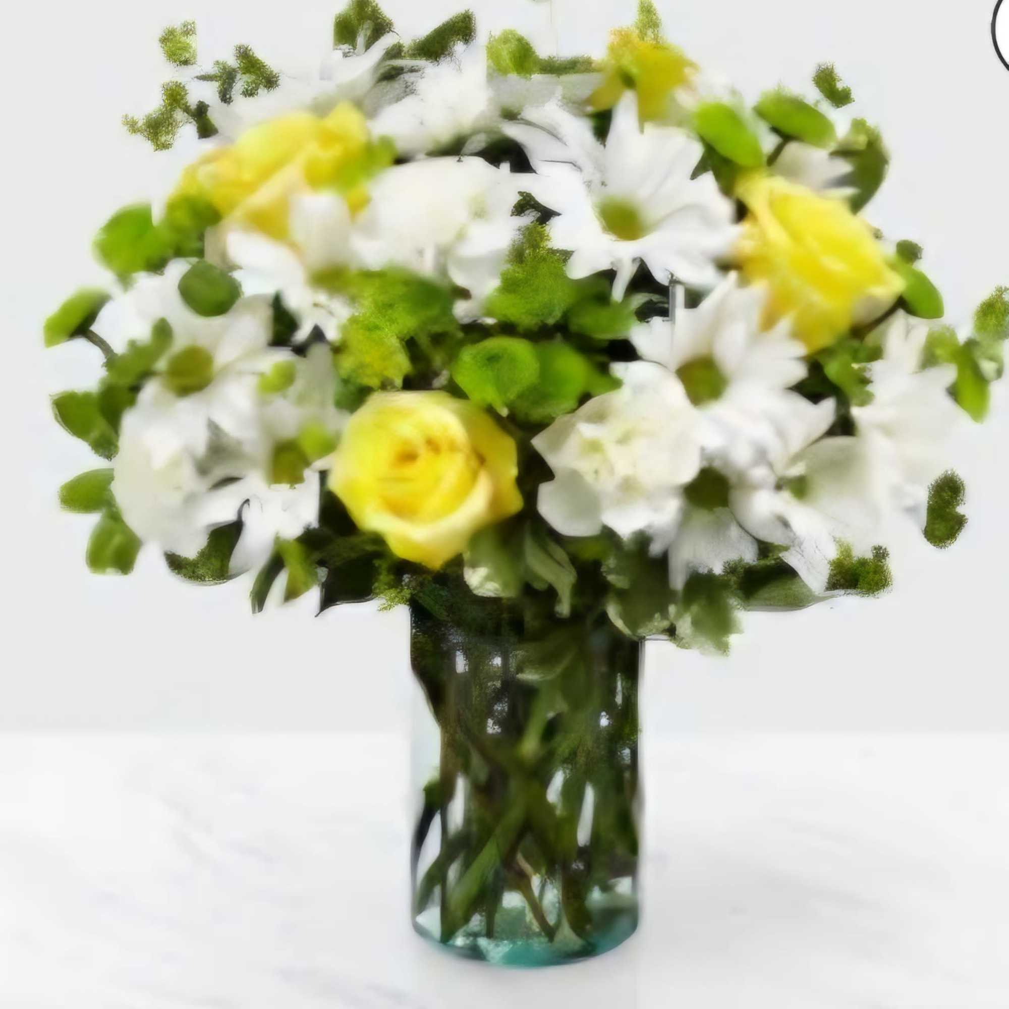 Yellow and white flowers arranged in a glass vase