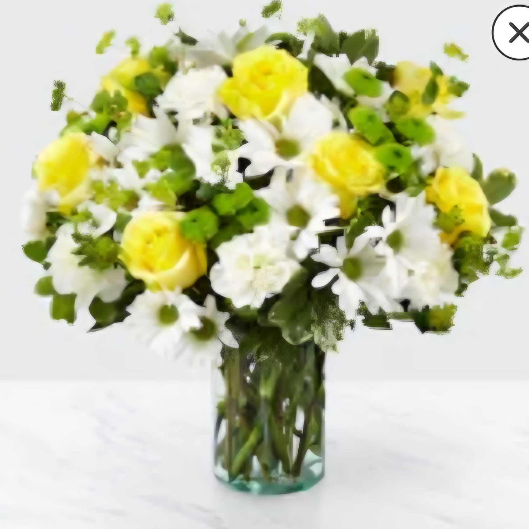Yellow roses and white daisies in a clear glass vase