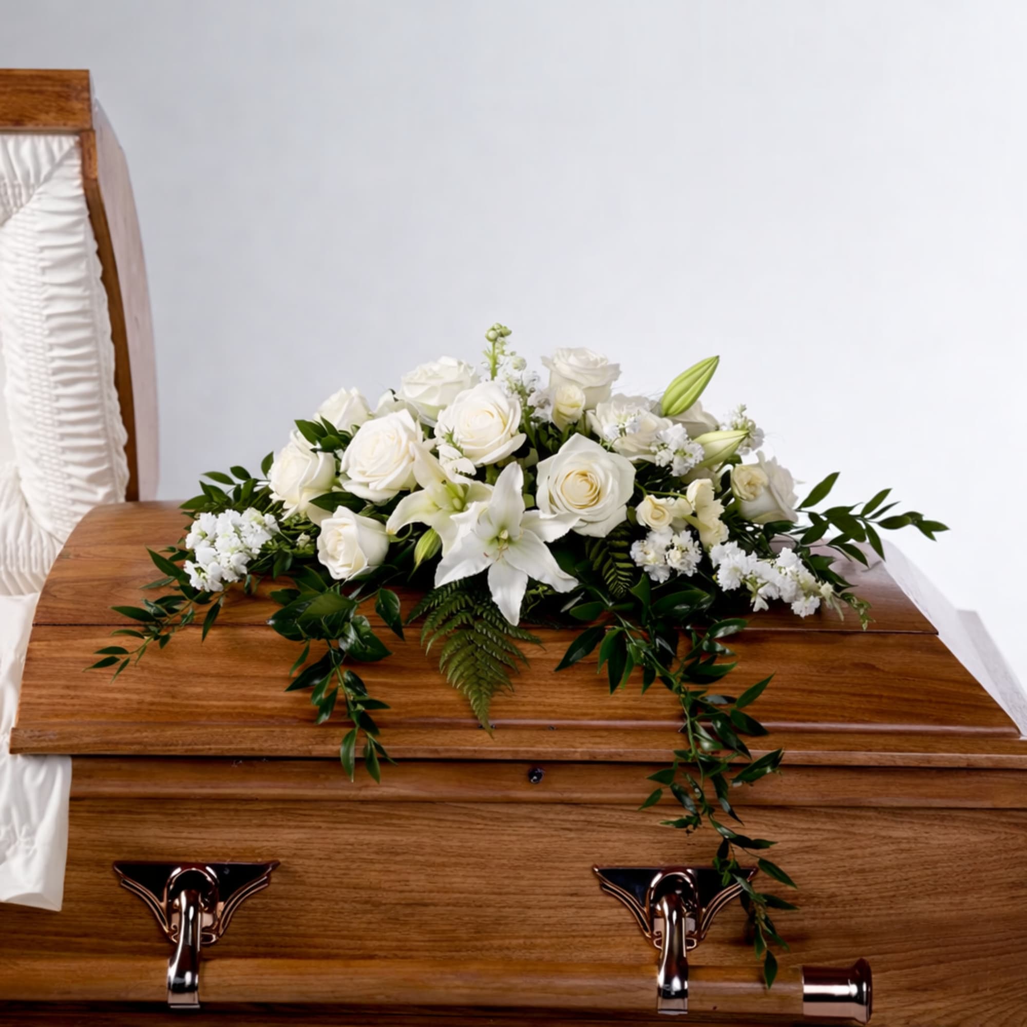 An all white tribute, this half casket spray is pure in color